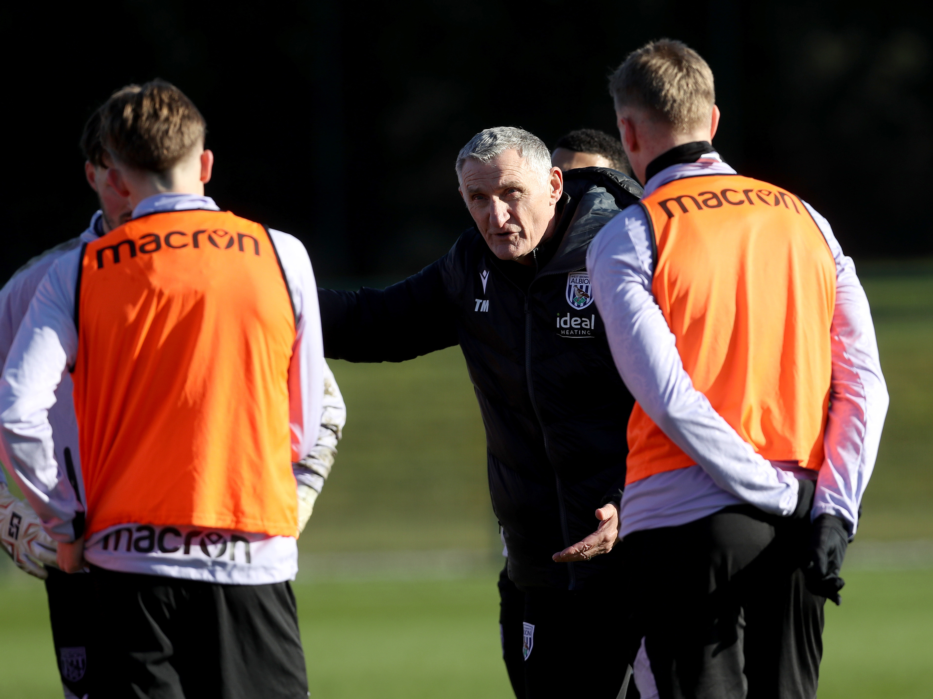 An image of Tony Mowbray talking to his players on the training pitch