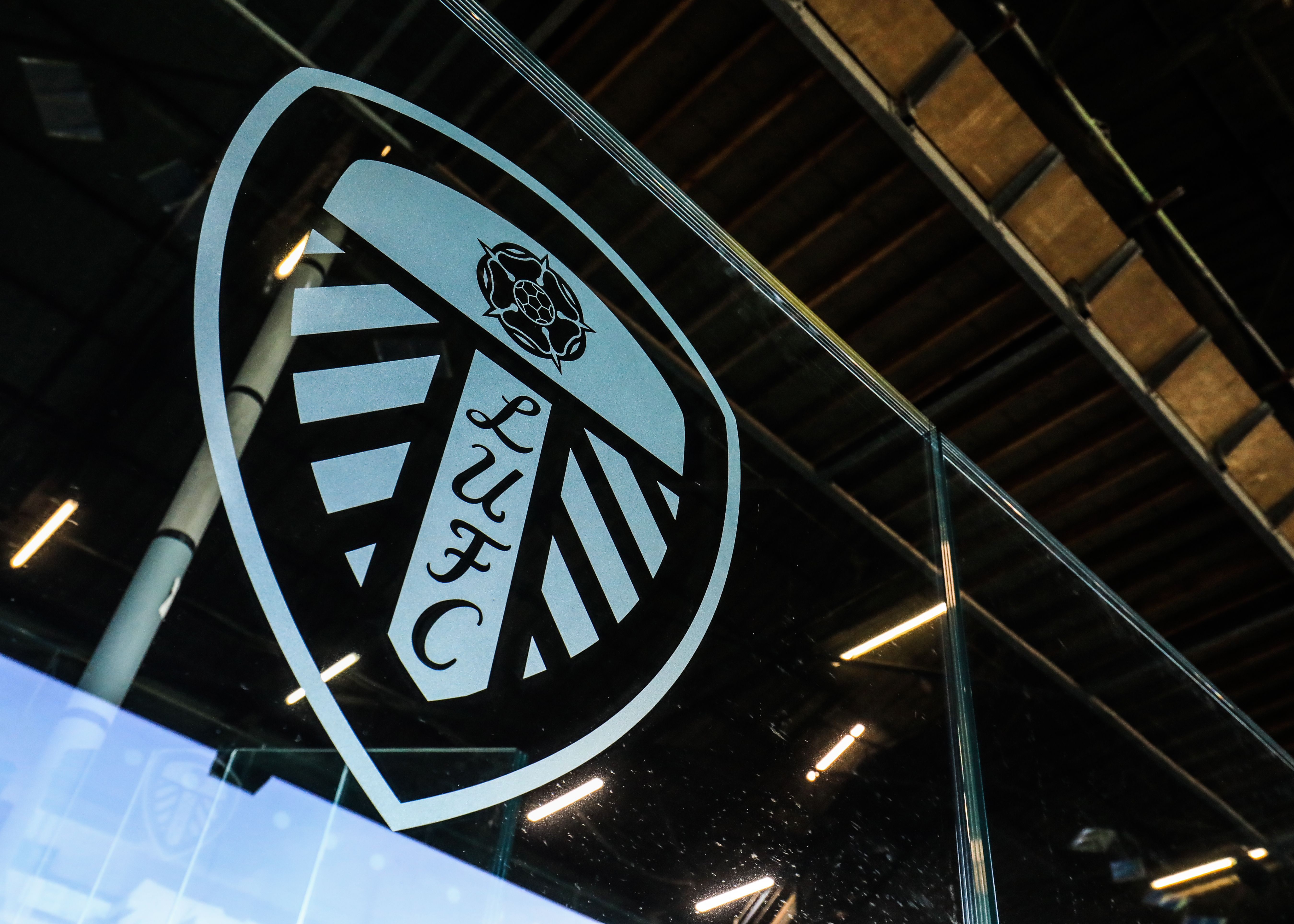 A Leeds badge on a piece of glass at Elland Road 