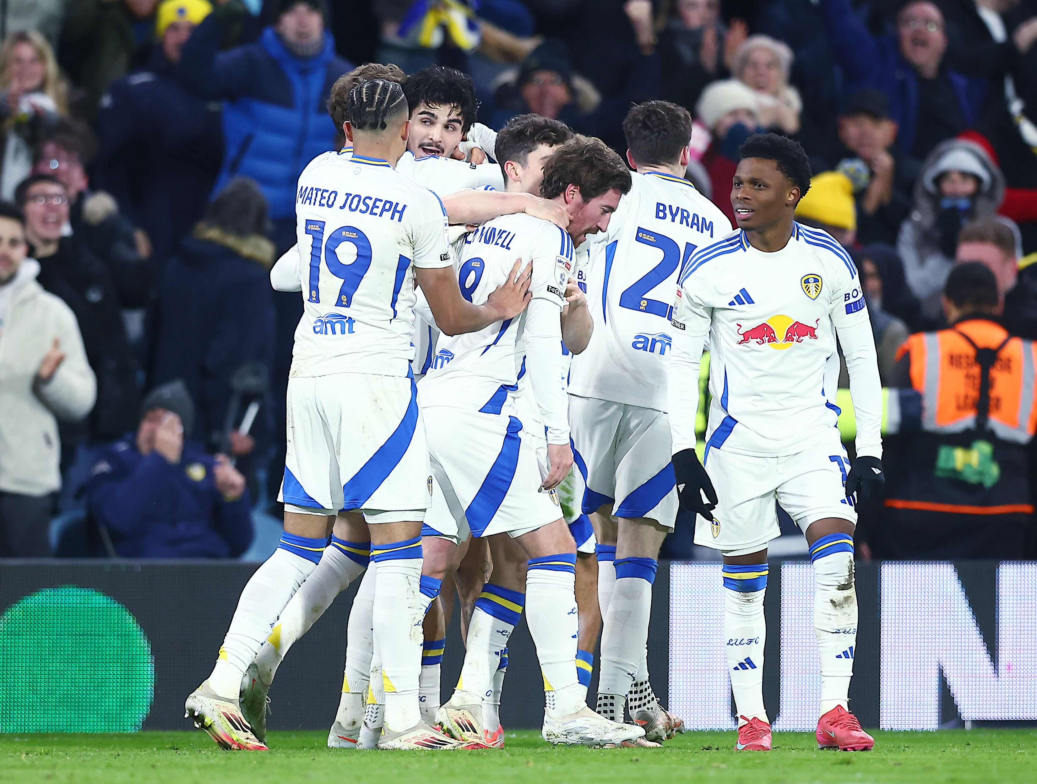 Several Leeds United players celebrate a goal scored in their home kit 