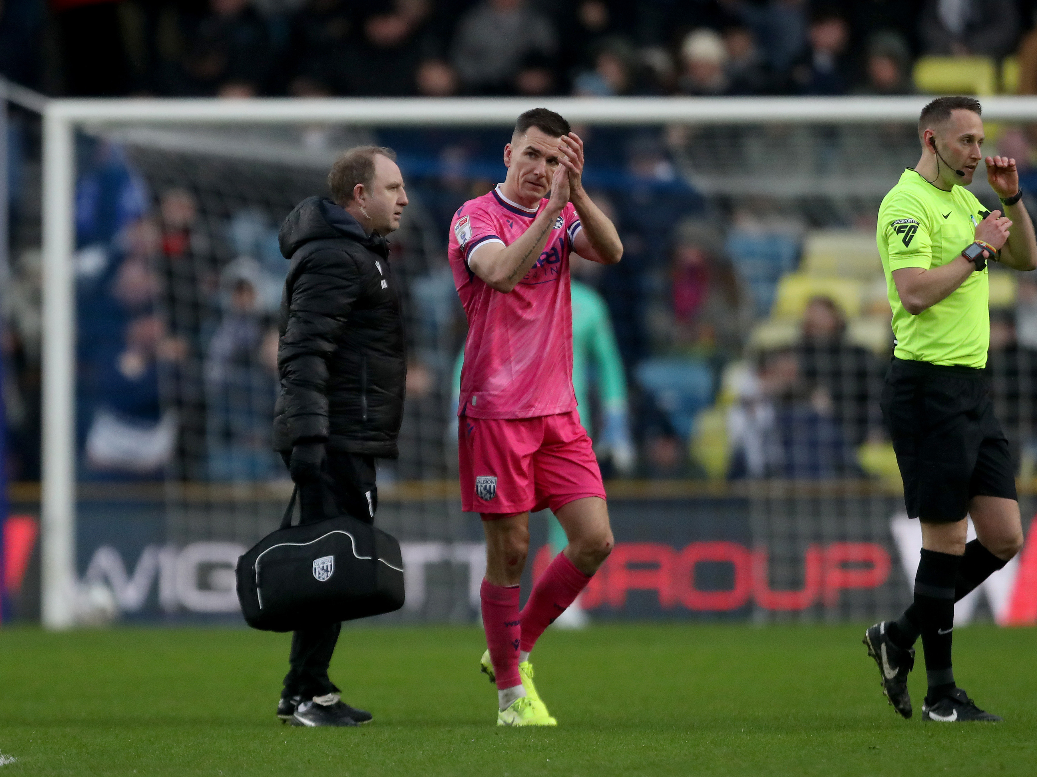 A photo of Albion skipper Jed Wallace in the 2024/25 pink away kit applauding supporters at Millwall