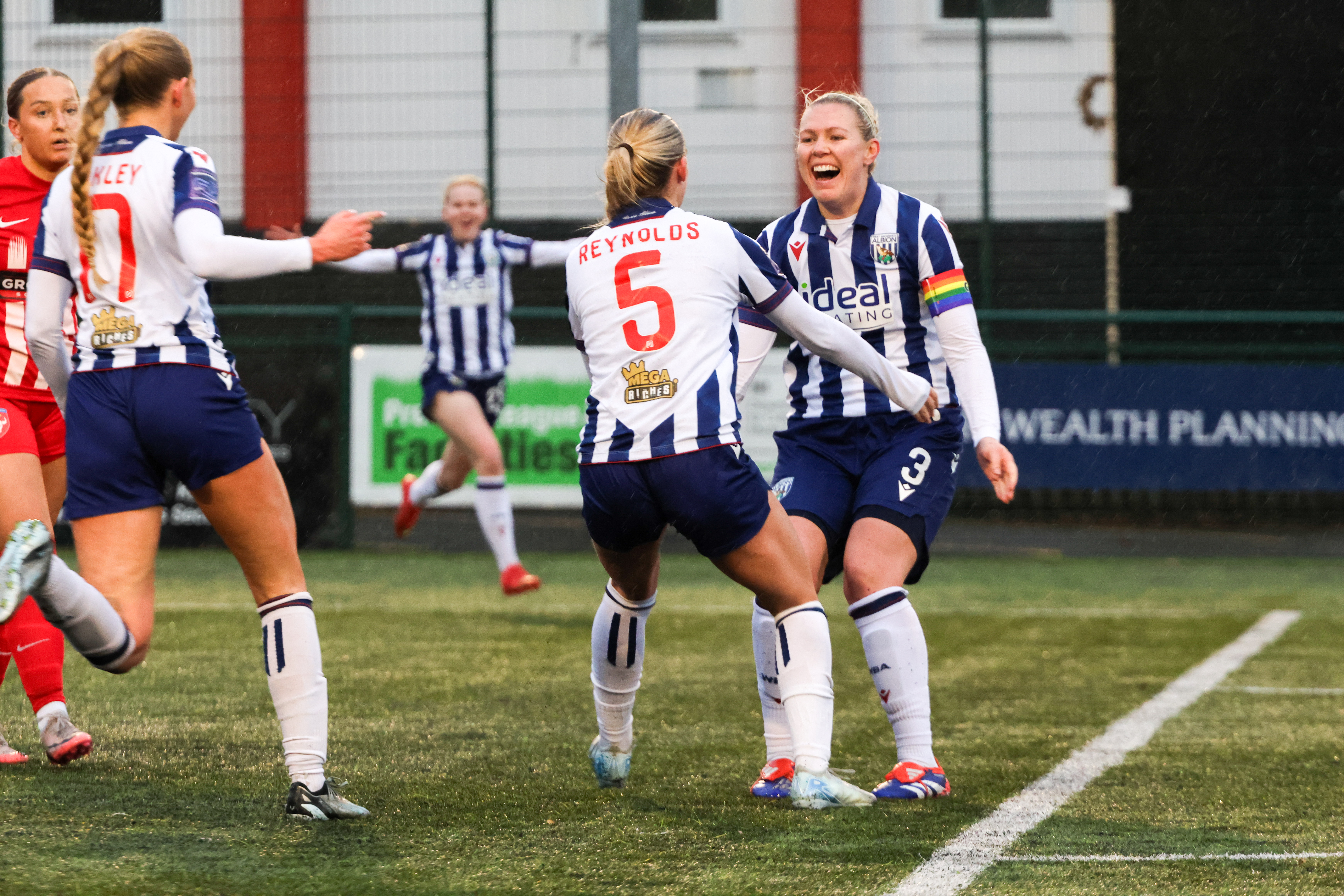 Hannah George celebrating a goal in the home kit with Taylor Reynolds 