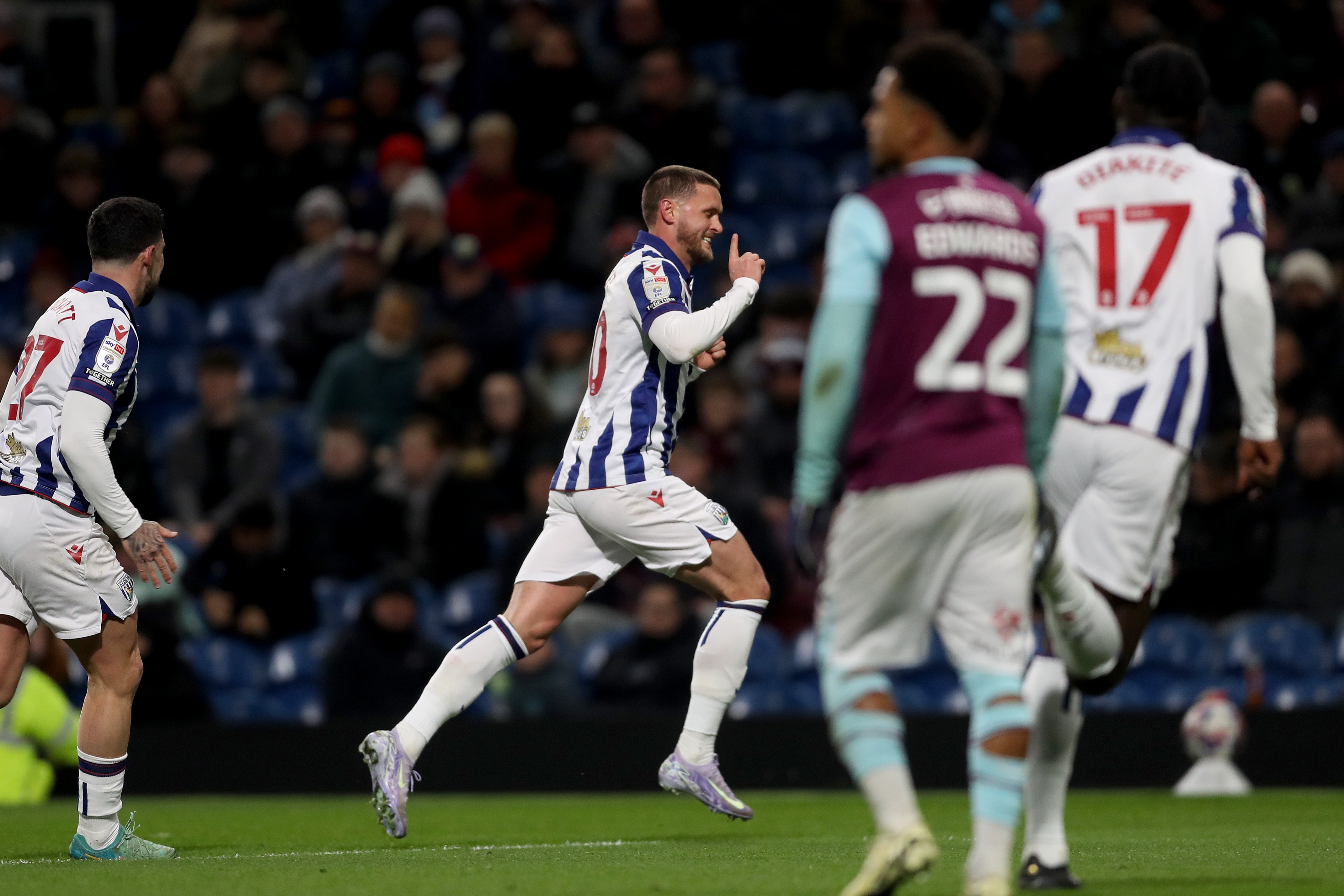 John Swift runs off celebrating a free-kick goal at Burnley 