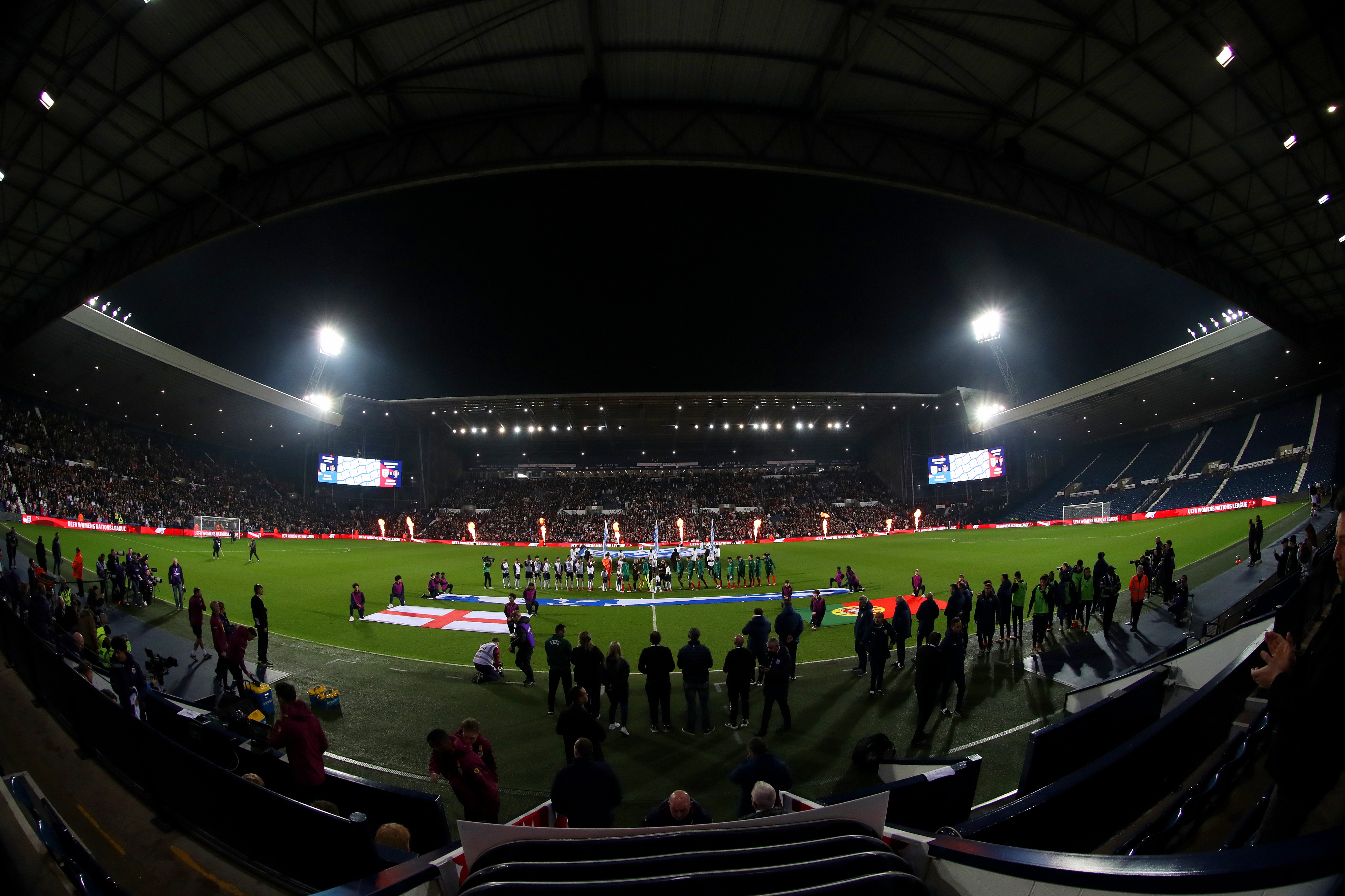 A general view of England and Portugal lining up before kick-off at The Hawthorns with the East Stand behind them