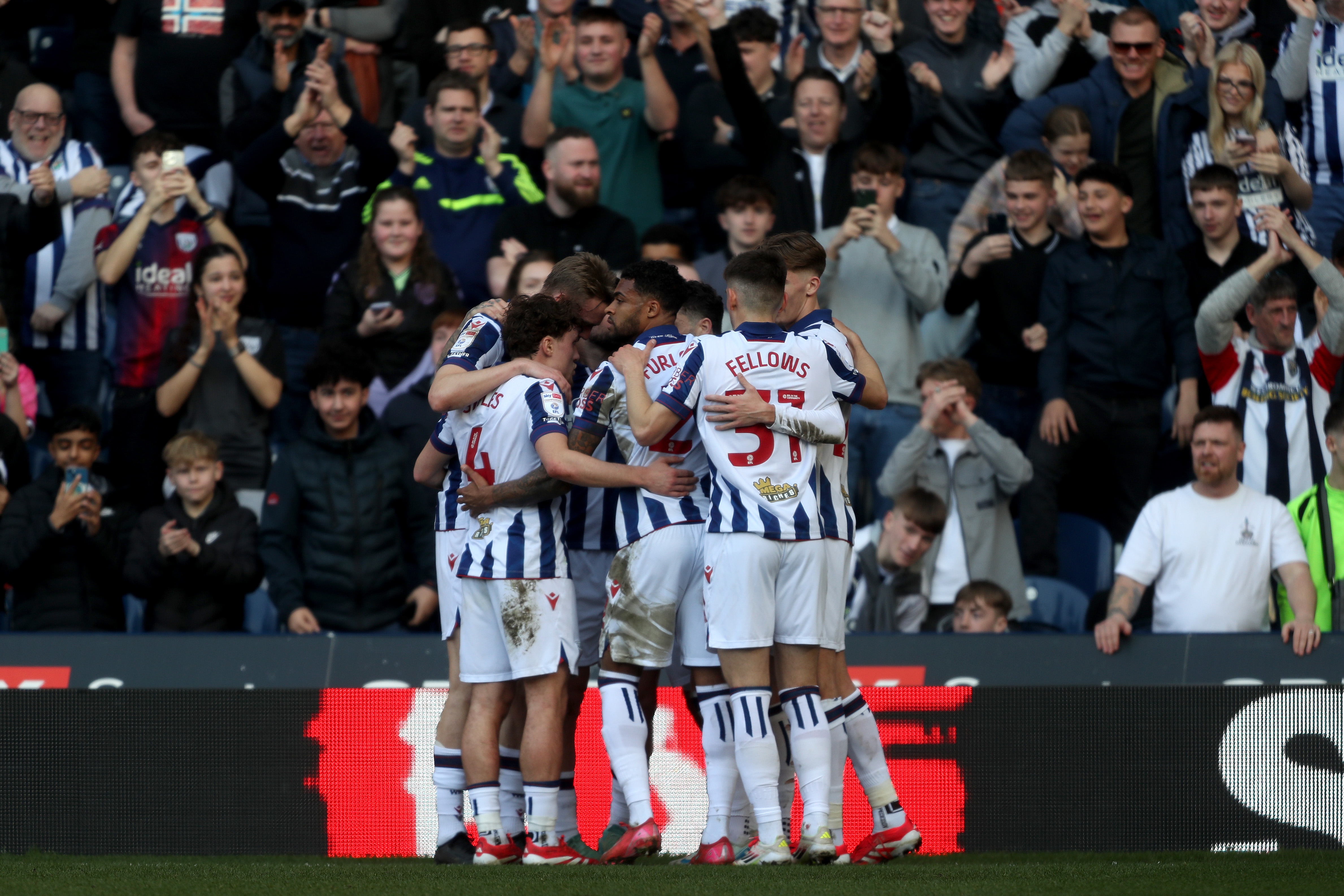 Adam Armstrong is mobbed by team-mates after scoring against QPR 