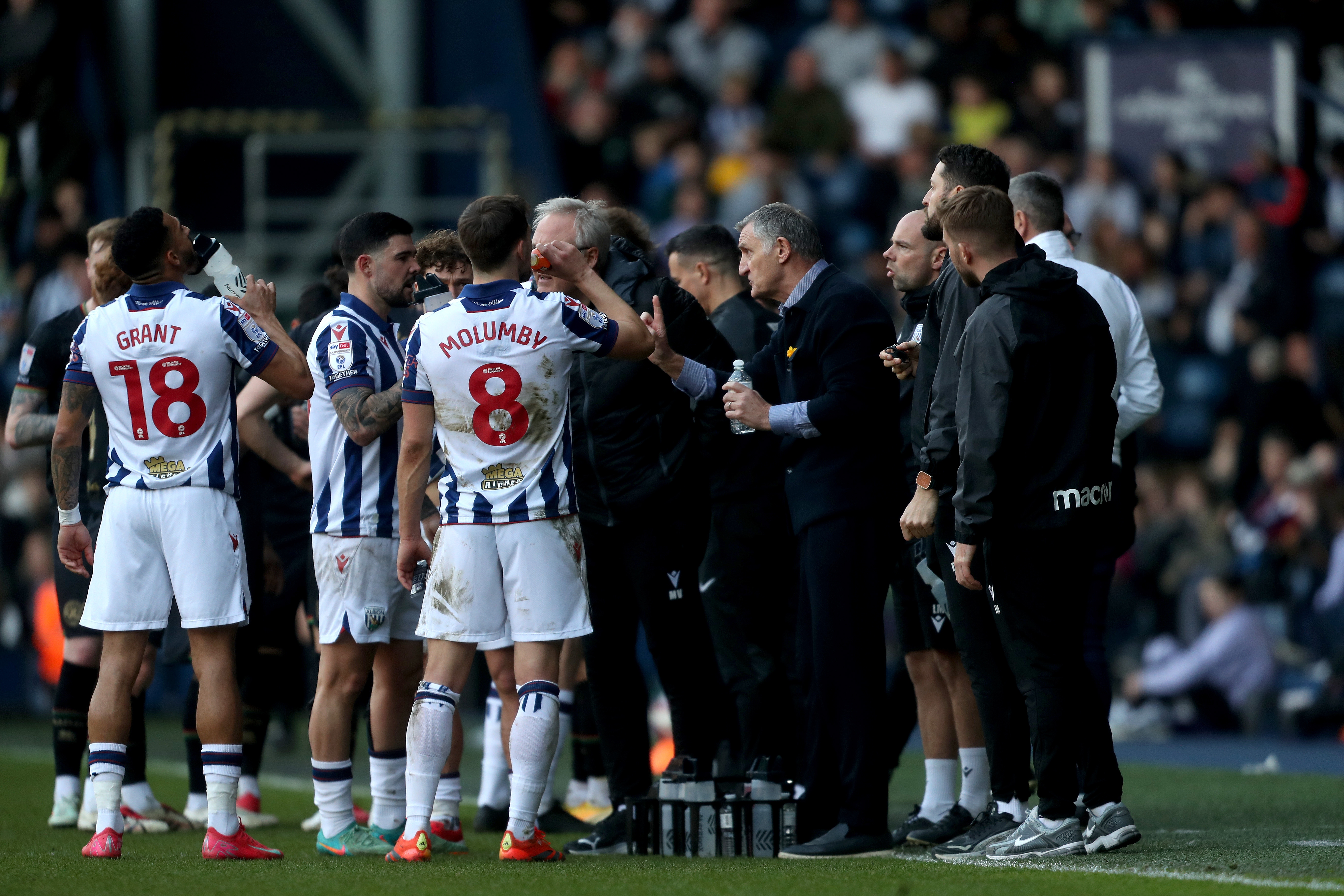 Tony Mowbray speaks to players on the side of the pitch during a stoppage against QPR 