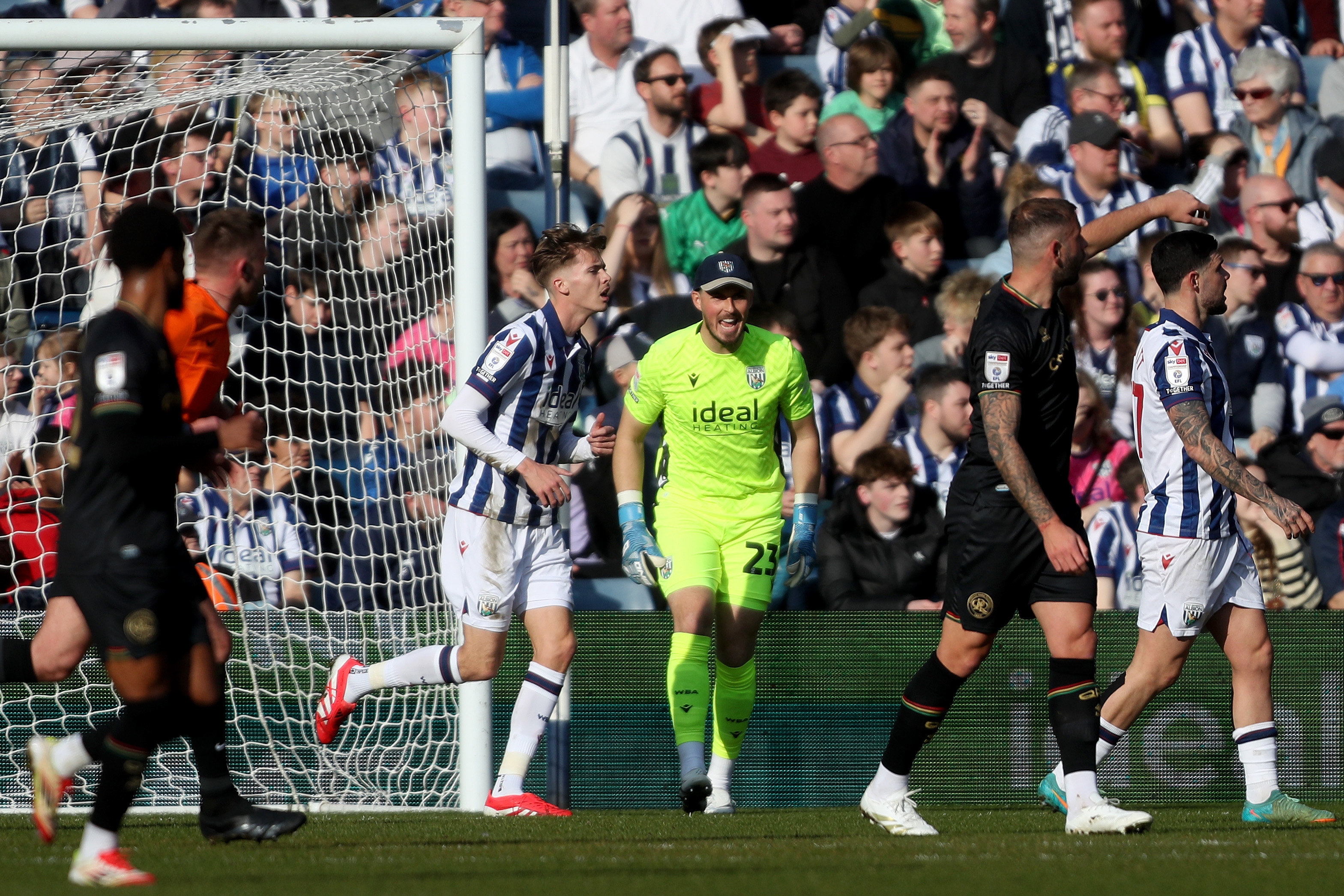 Joe Wildsmith wearing a cap and shouting during the game against QPR 