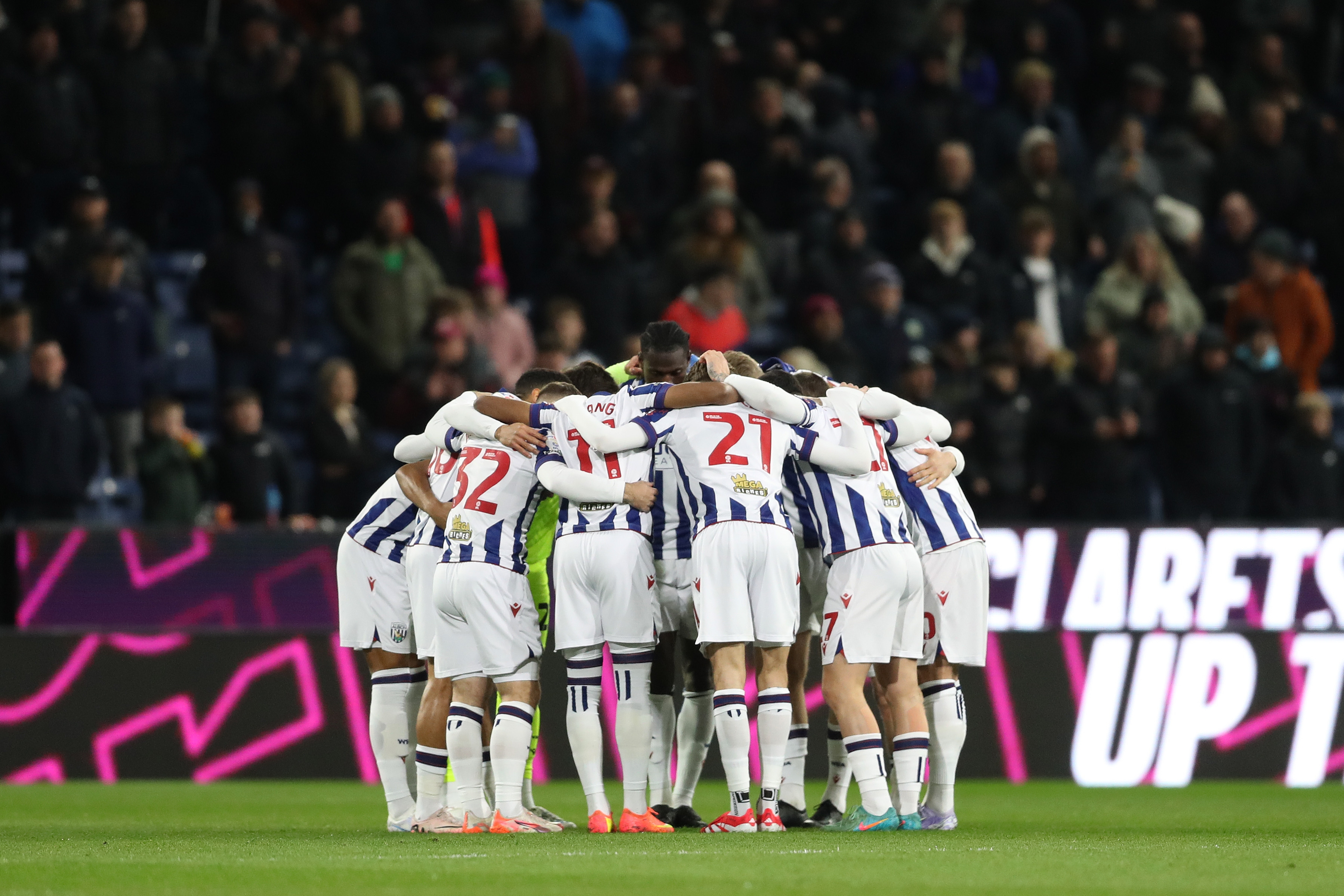 Albion team at Burnley in a pre-match huddle on the pitch