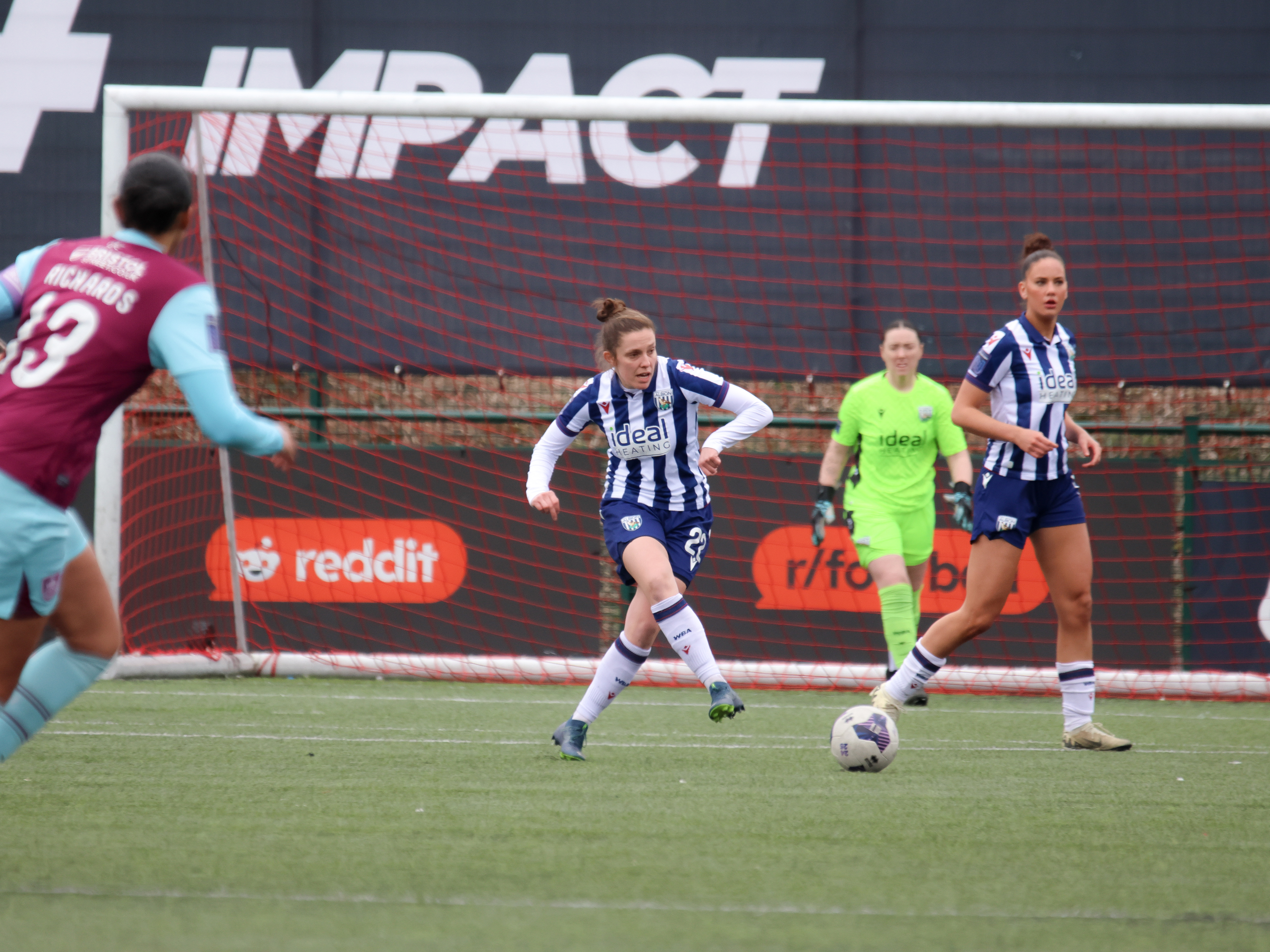 An image of Kate Evans playing against Burnley for Albion Women