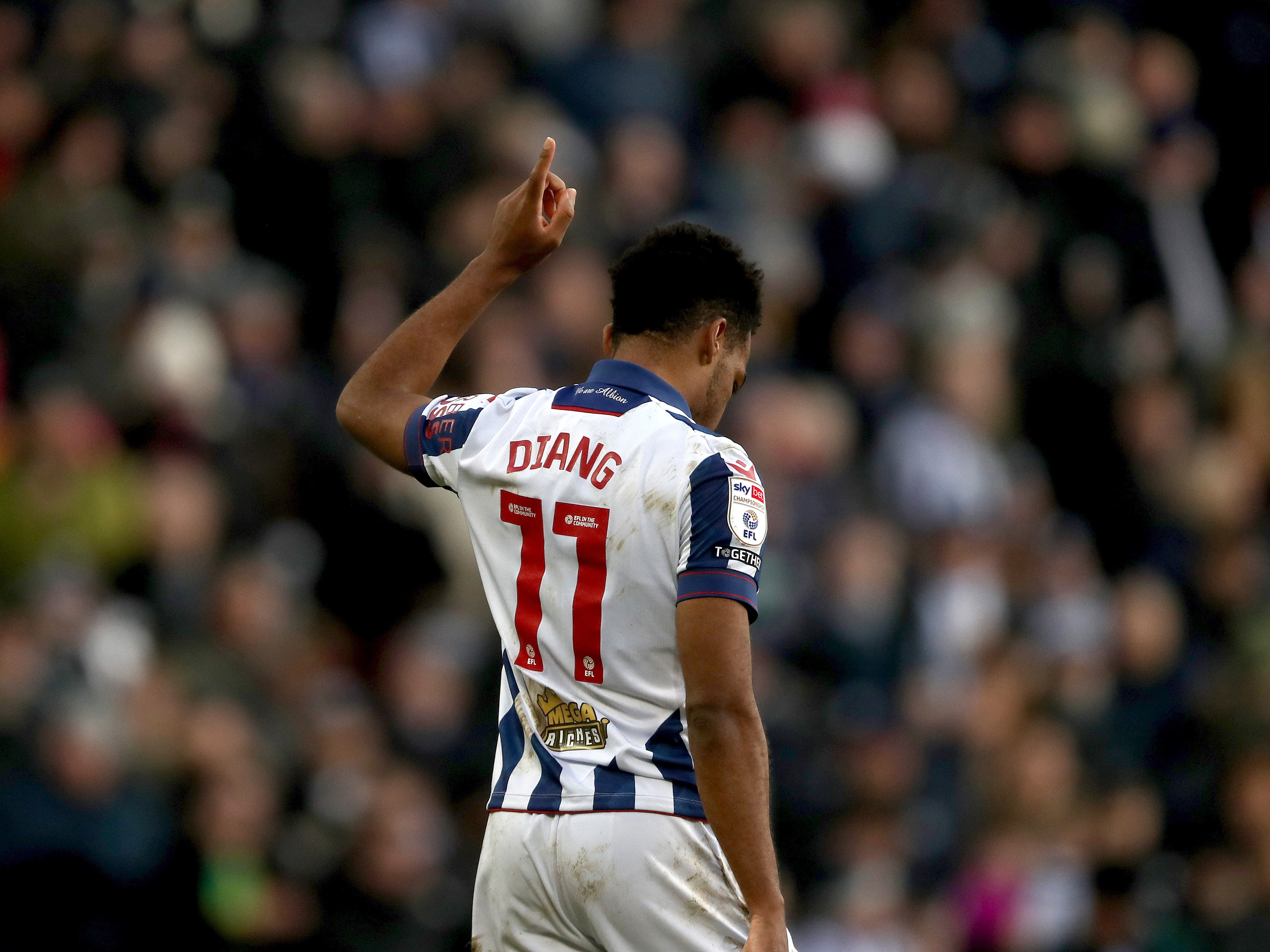 Grady Diangana celebrates scoring a goal at The Hawthorns in the home kit 