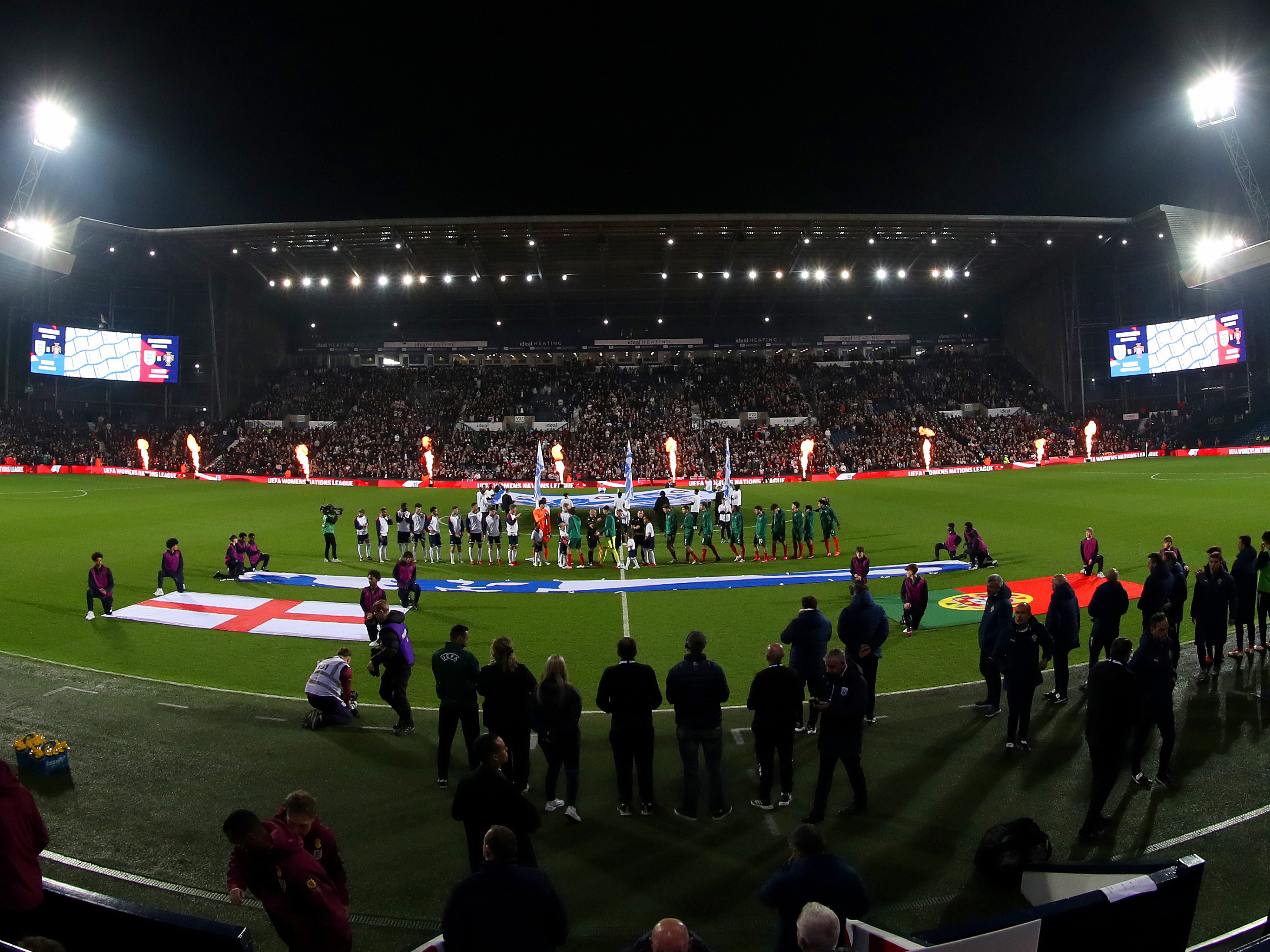 A general view of England and Portugal lining up at The Hawthorns before the match with the East Stand behind them