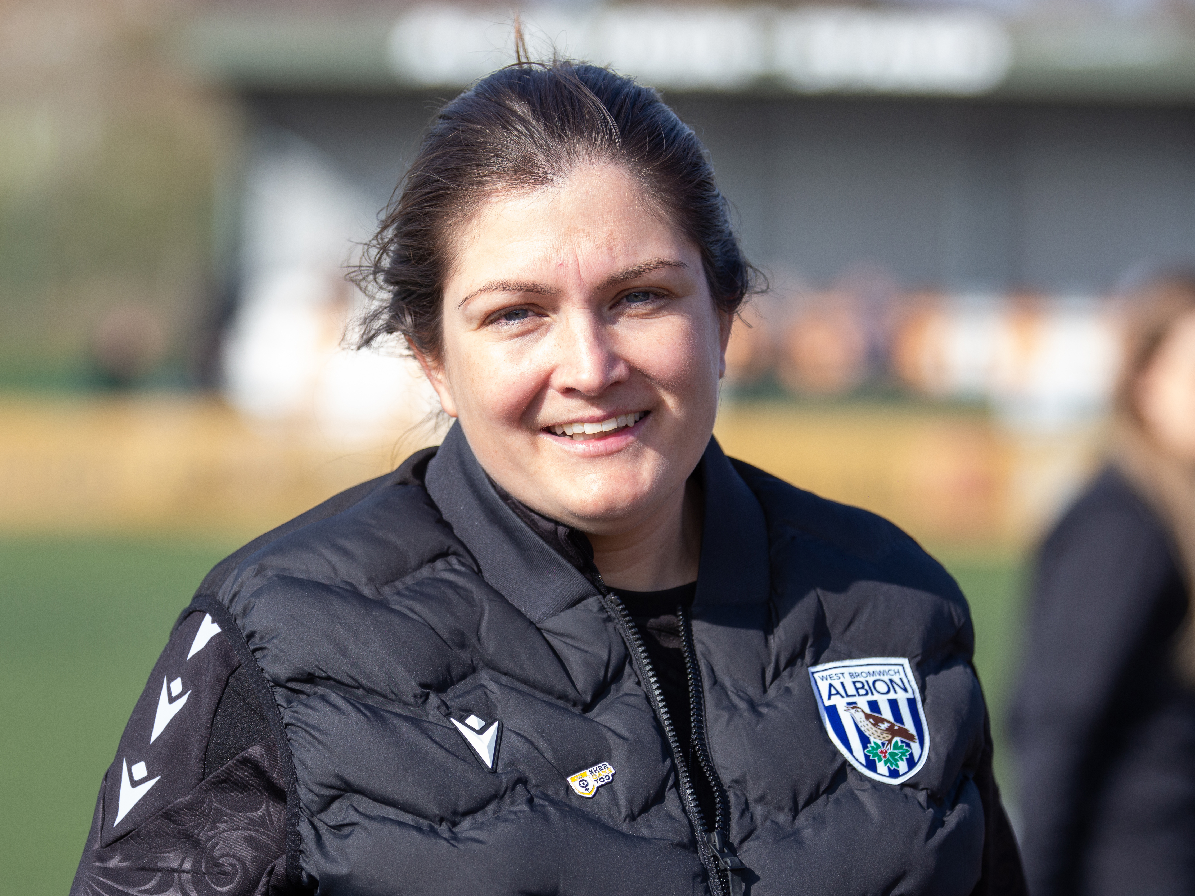 Siobhan Hodgetts-Still smiling while wearing a black WBA coat 