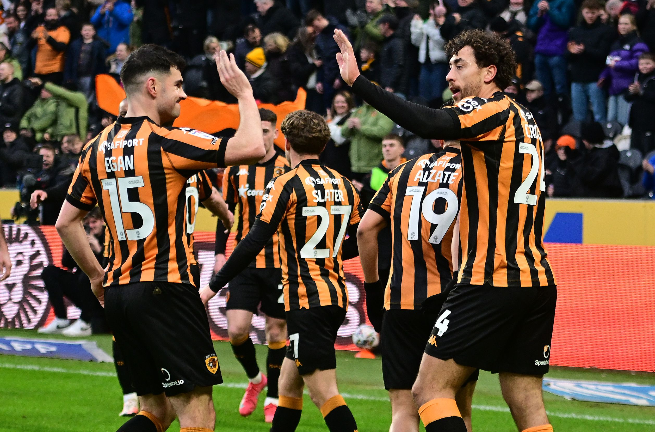 Several Hull City players celebrate a goal scored in their home kit 