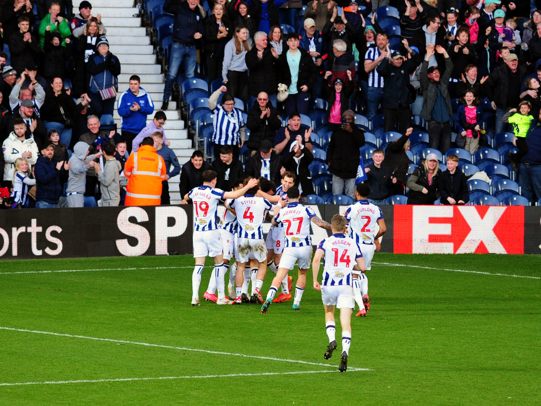 An image of Albion celebrating with supporters after John Swift's late goal against Oxford