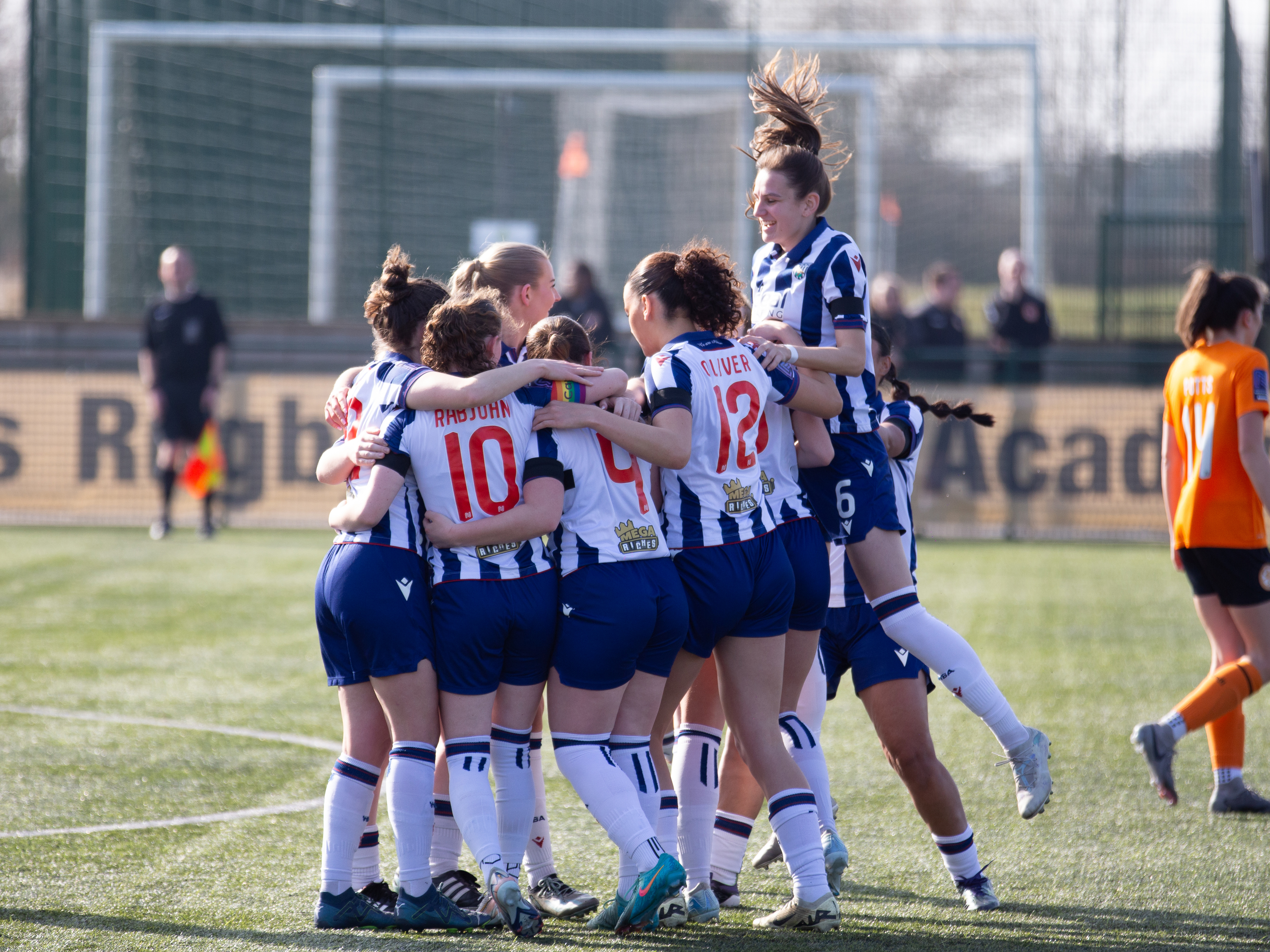 An image of Albion Women celebrating Liv Rabjohn's goal against Rugby