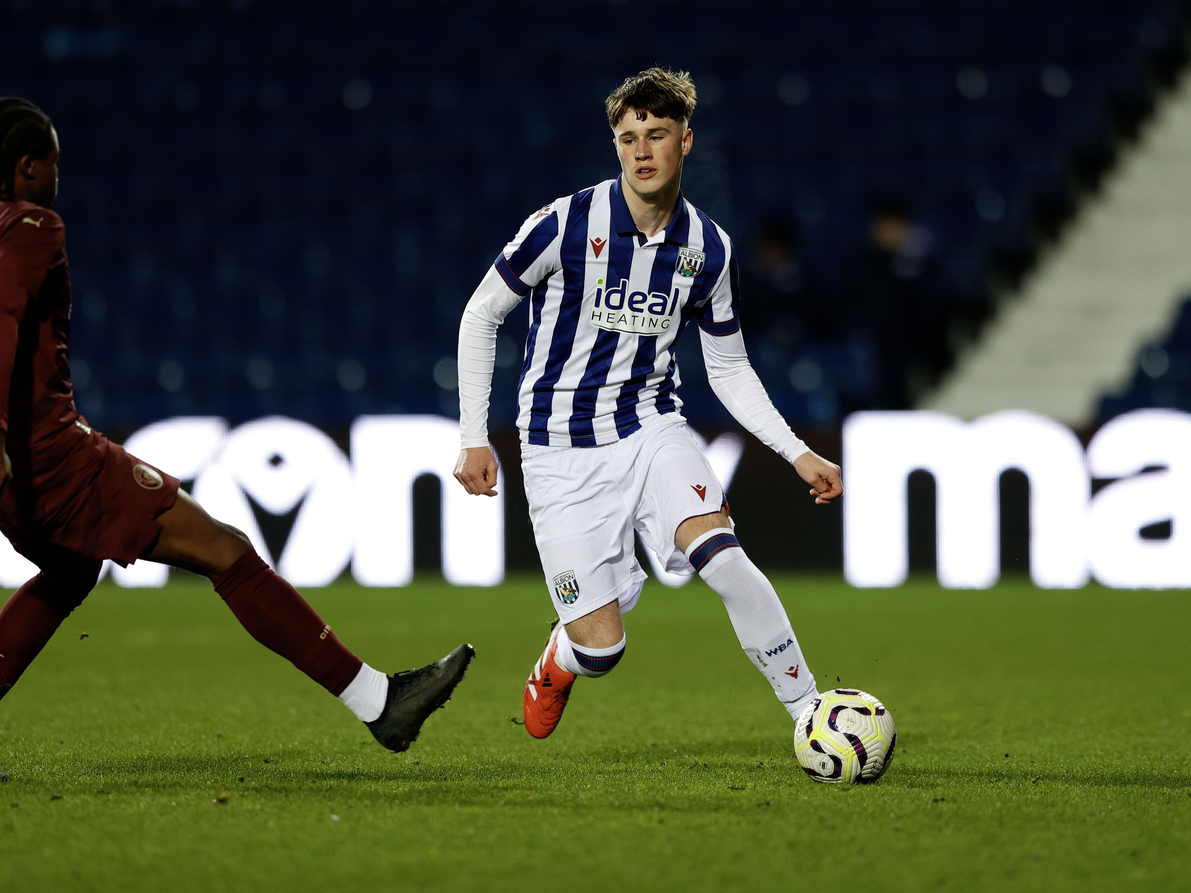 A photo of Albion U18 defender George Shaw in the 2024/25 home kit