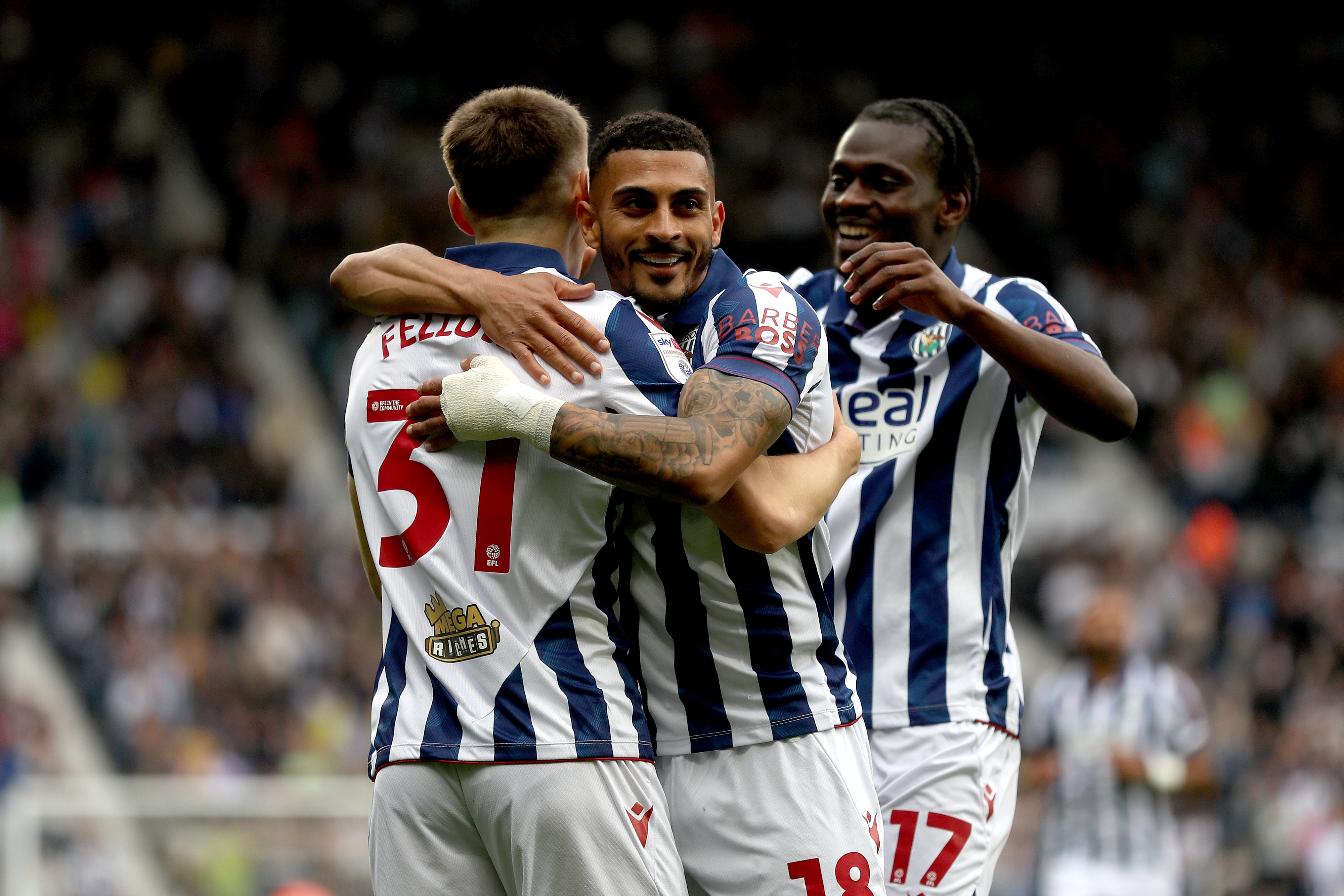 Tom Fellows celebrates with team-mates after scoring against Luton Town