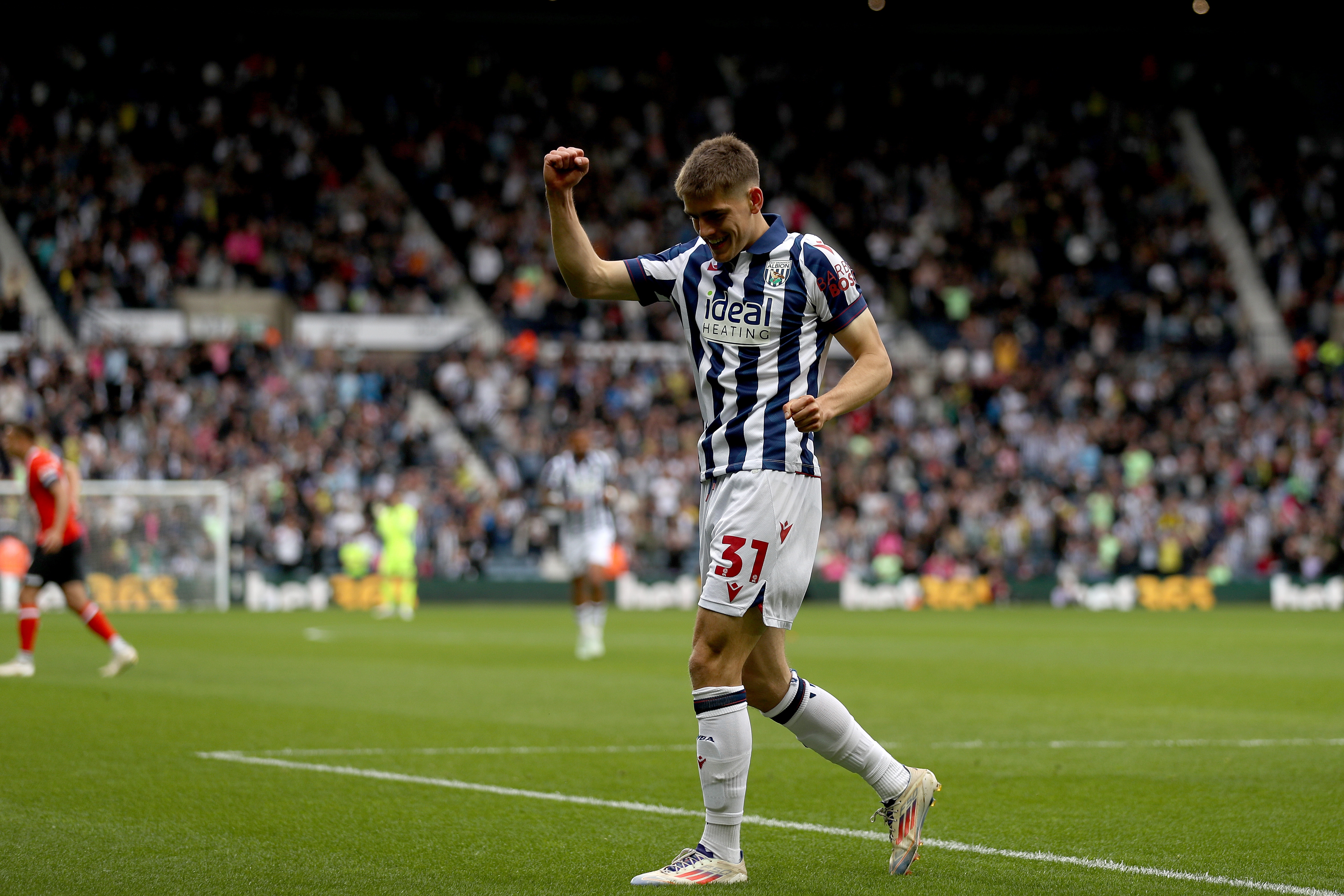 Tom Fellows celebrates alone after scoring against Luton Town