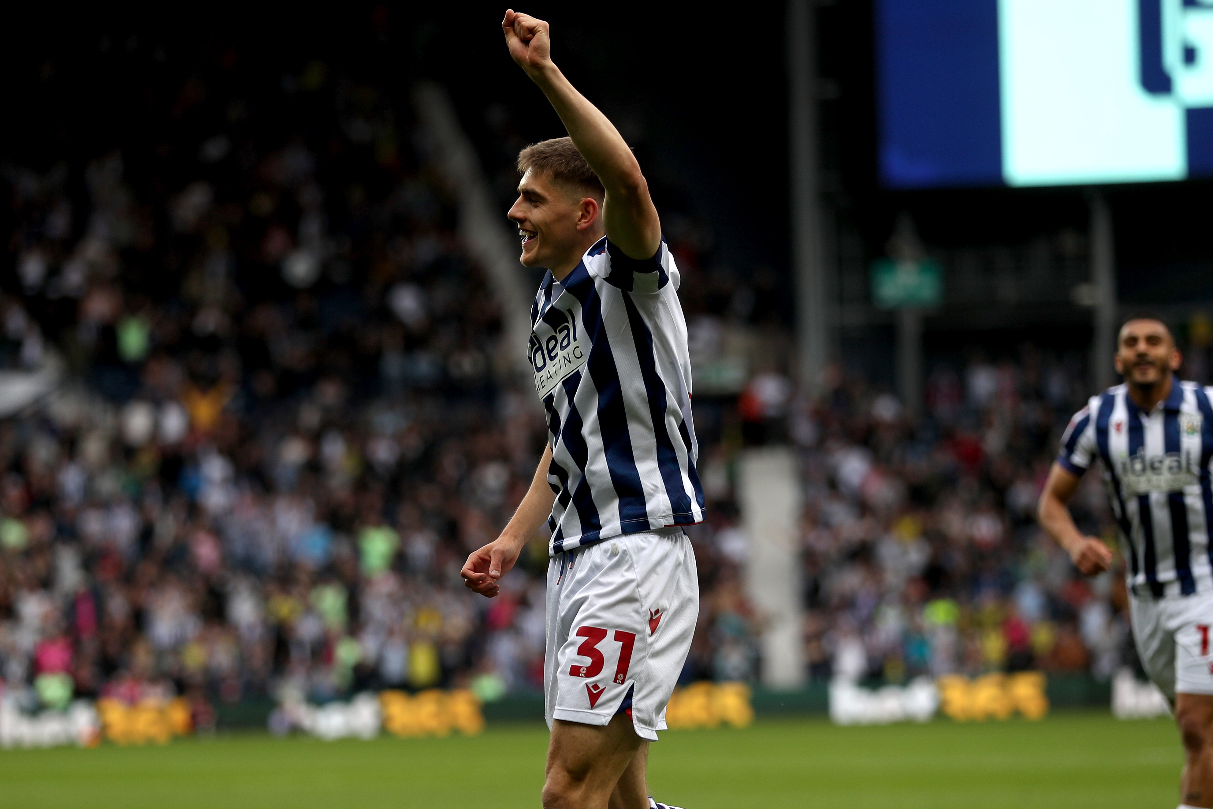 Tom Fellows celebrates alone after scoring against Luton Town