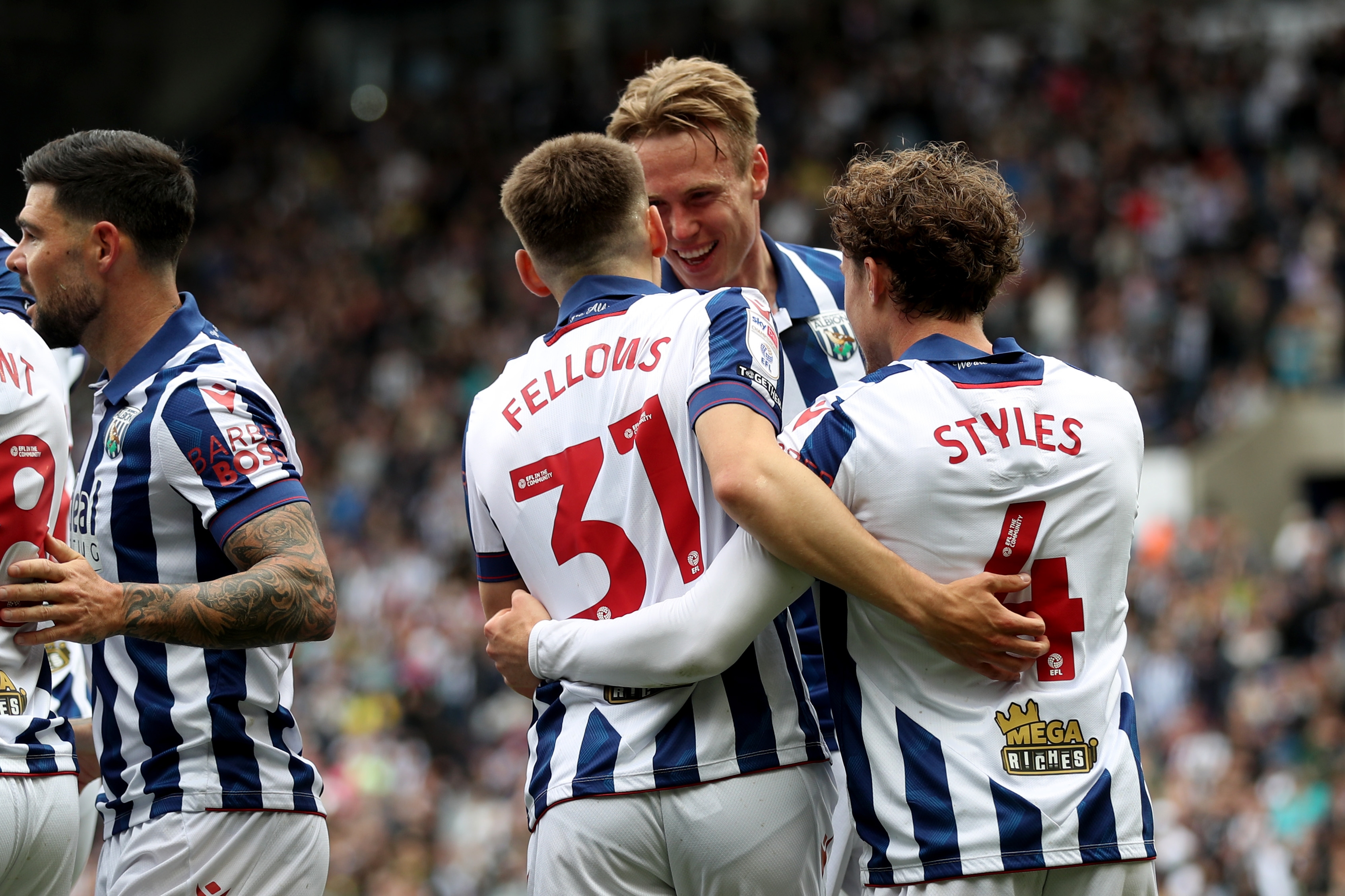 Tom Fellows celebrates with team-mates after scoring against Luton Town