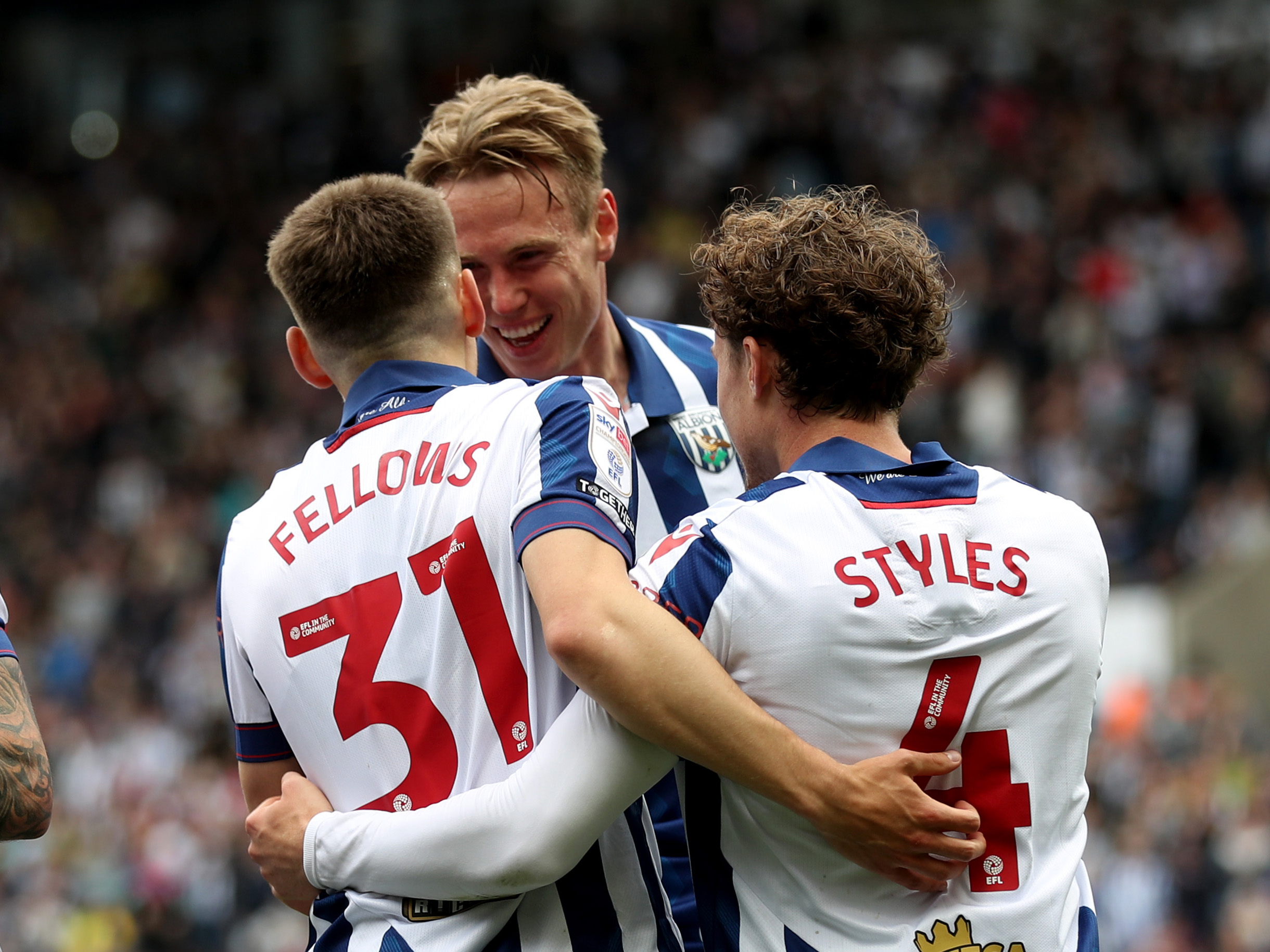 Tom Fellows and Callum Styles celebrate a goal with Torbjørn Heggem in the home kit