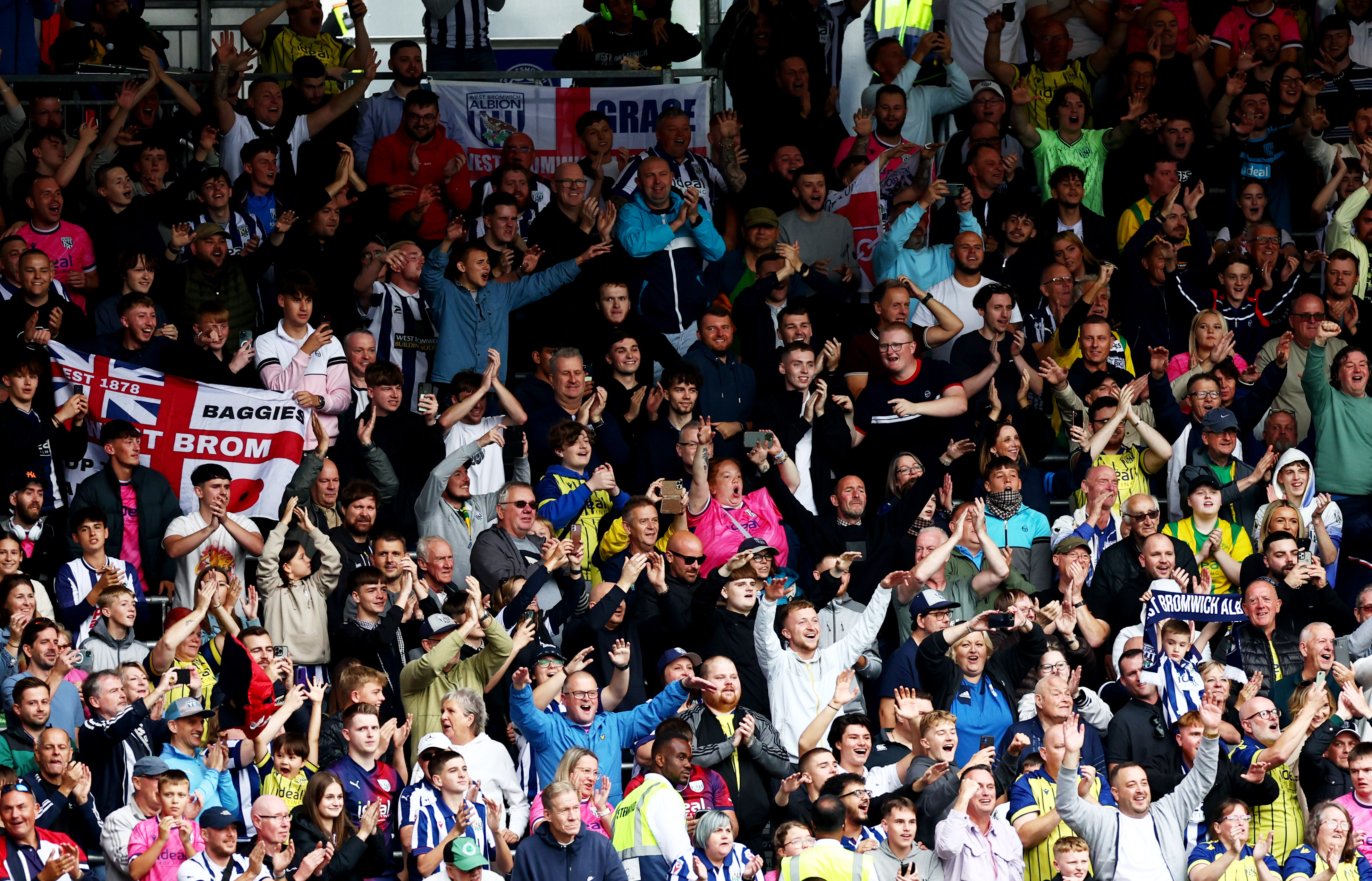 A general view of hundreds of Albion fans cheering at a game