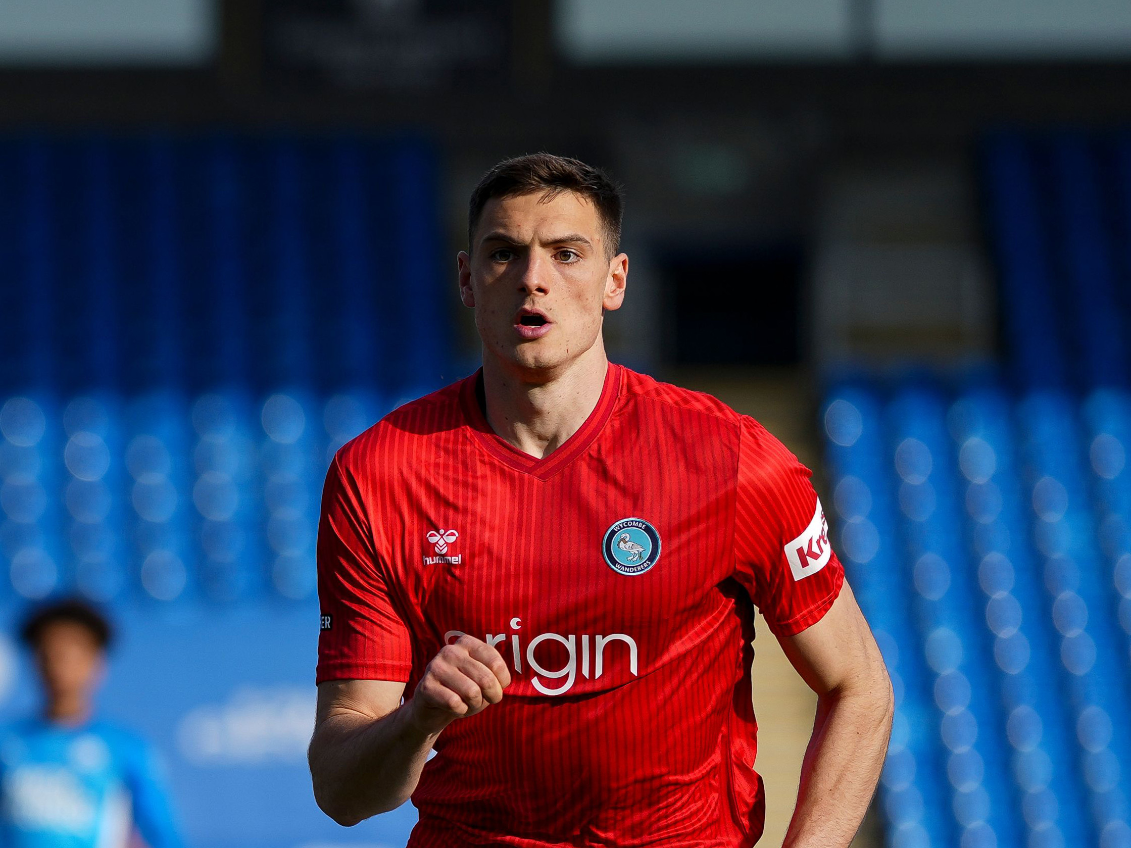 Caleb Taylor in action for Wycombe in their red away kit 