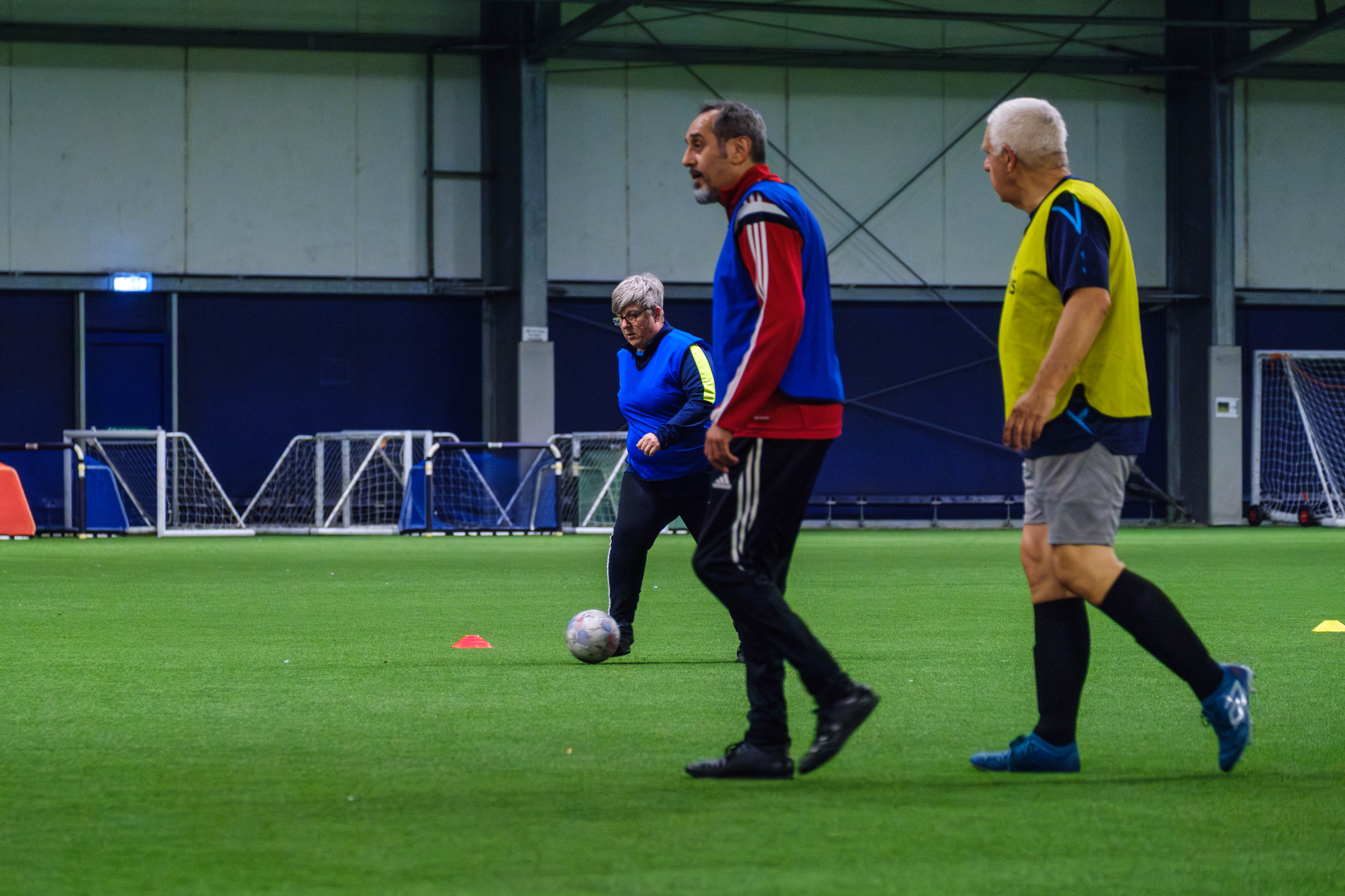 Adult participants playing football.