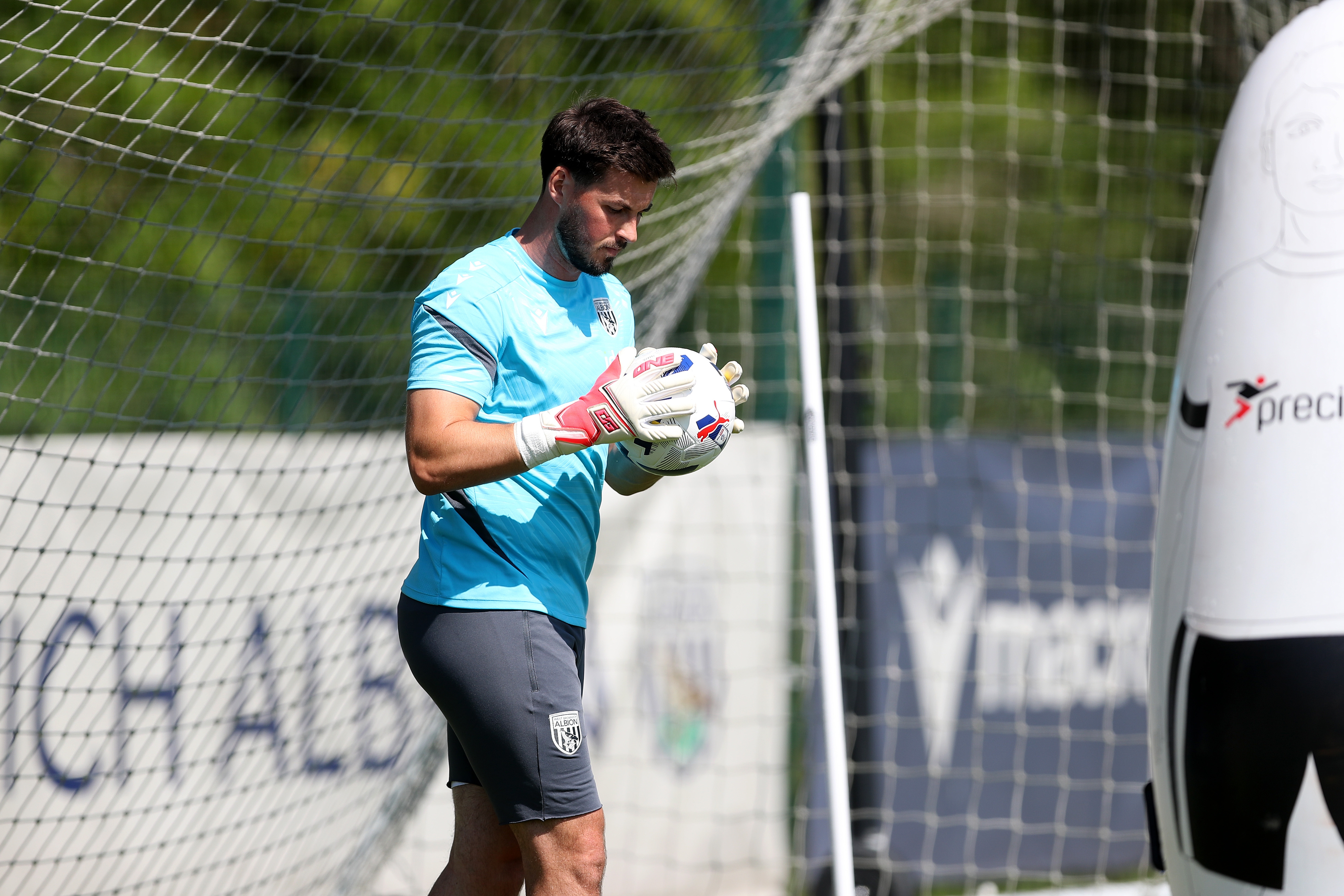 Joe Wildsmith holding a ball during a training session