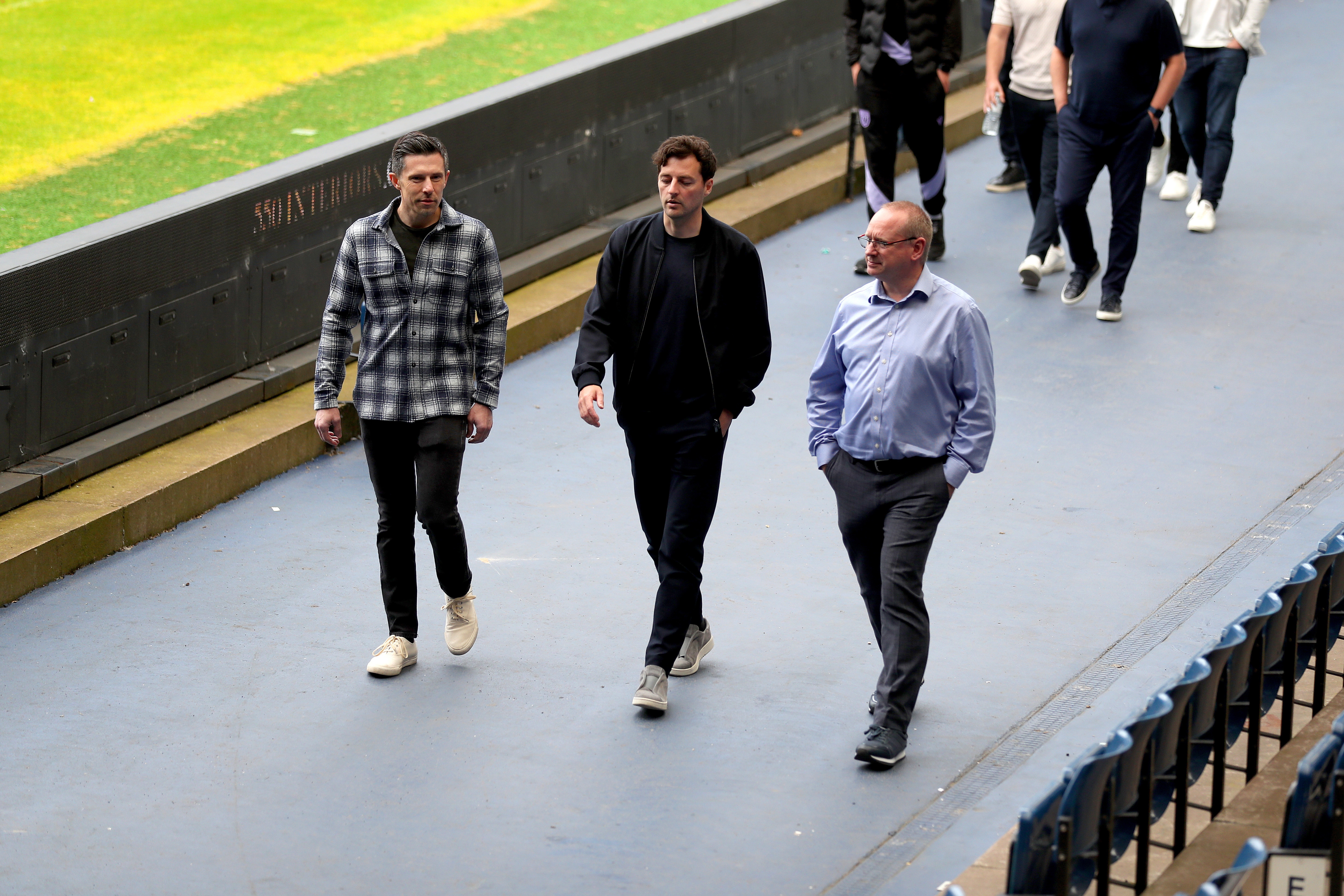 Ryan Mason walking around the side of the pitch at The Hawthorns with Andrew Nestor and Mark Miles