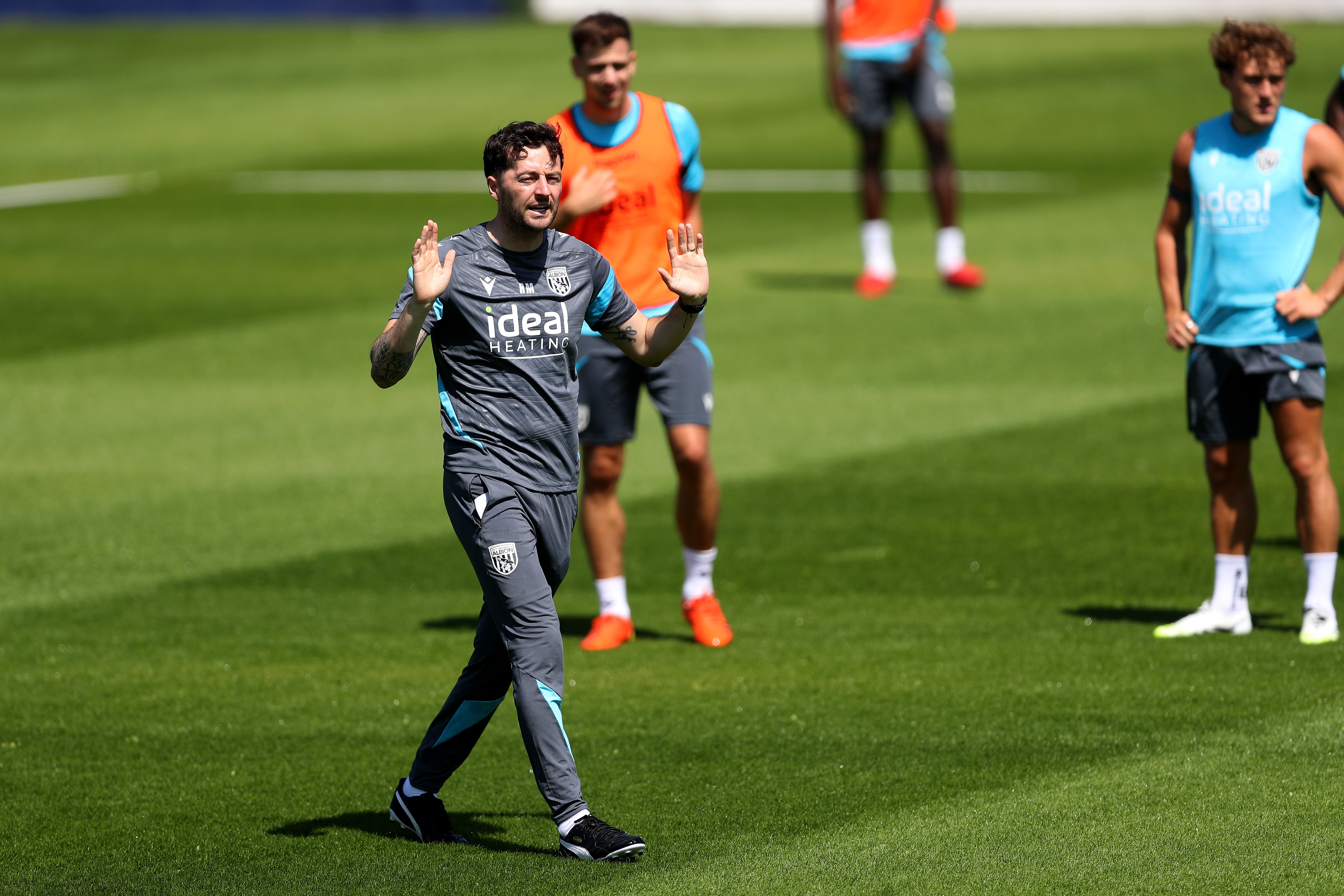 Ryan Mason delivering instructions to his players during a training session