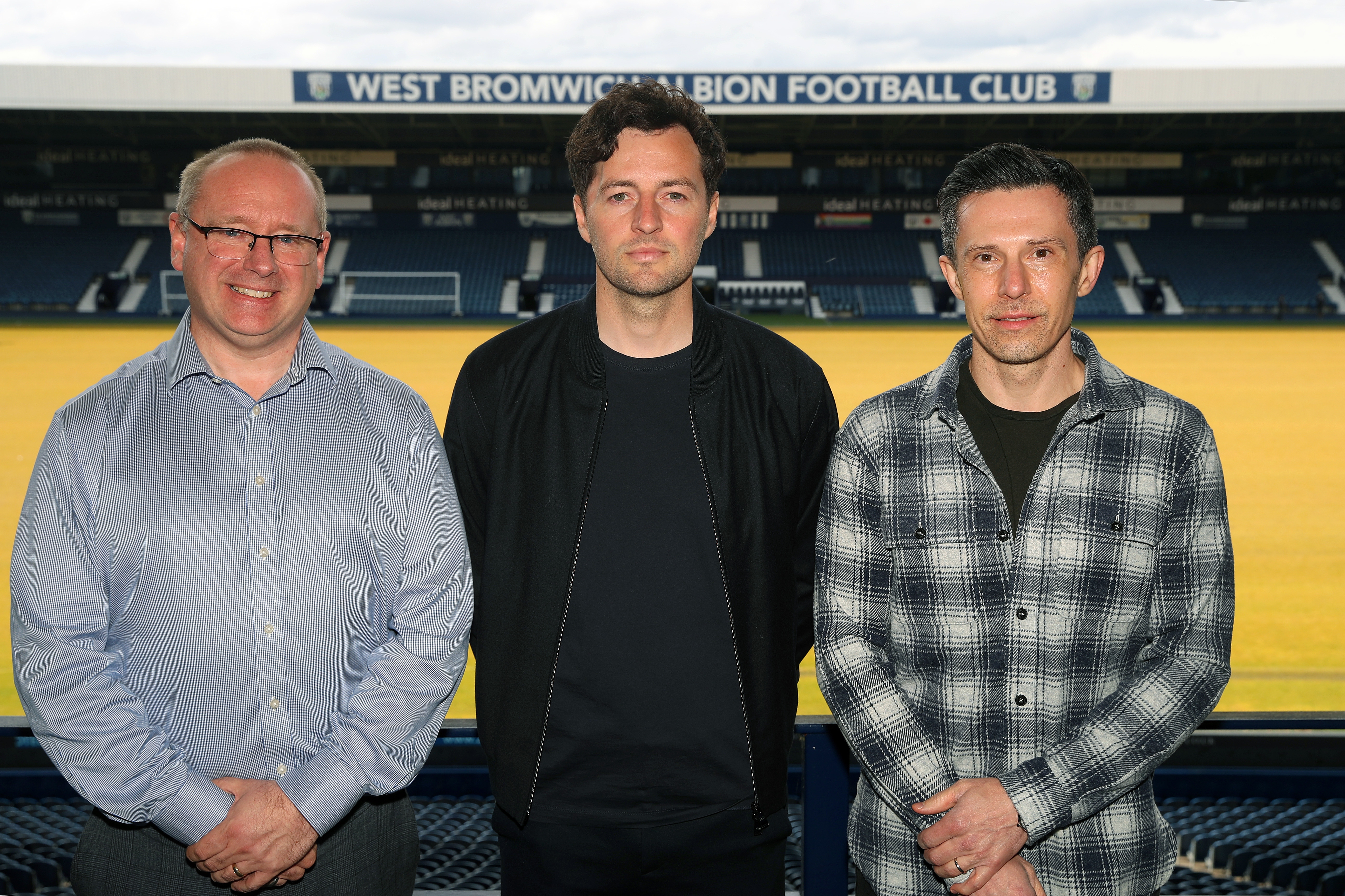 Mark Miles, Ryan Mason and Andrew Nestor posing for a photo at The Hawthorns with the West Stand behind them