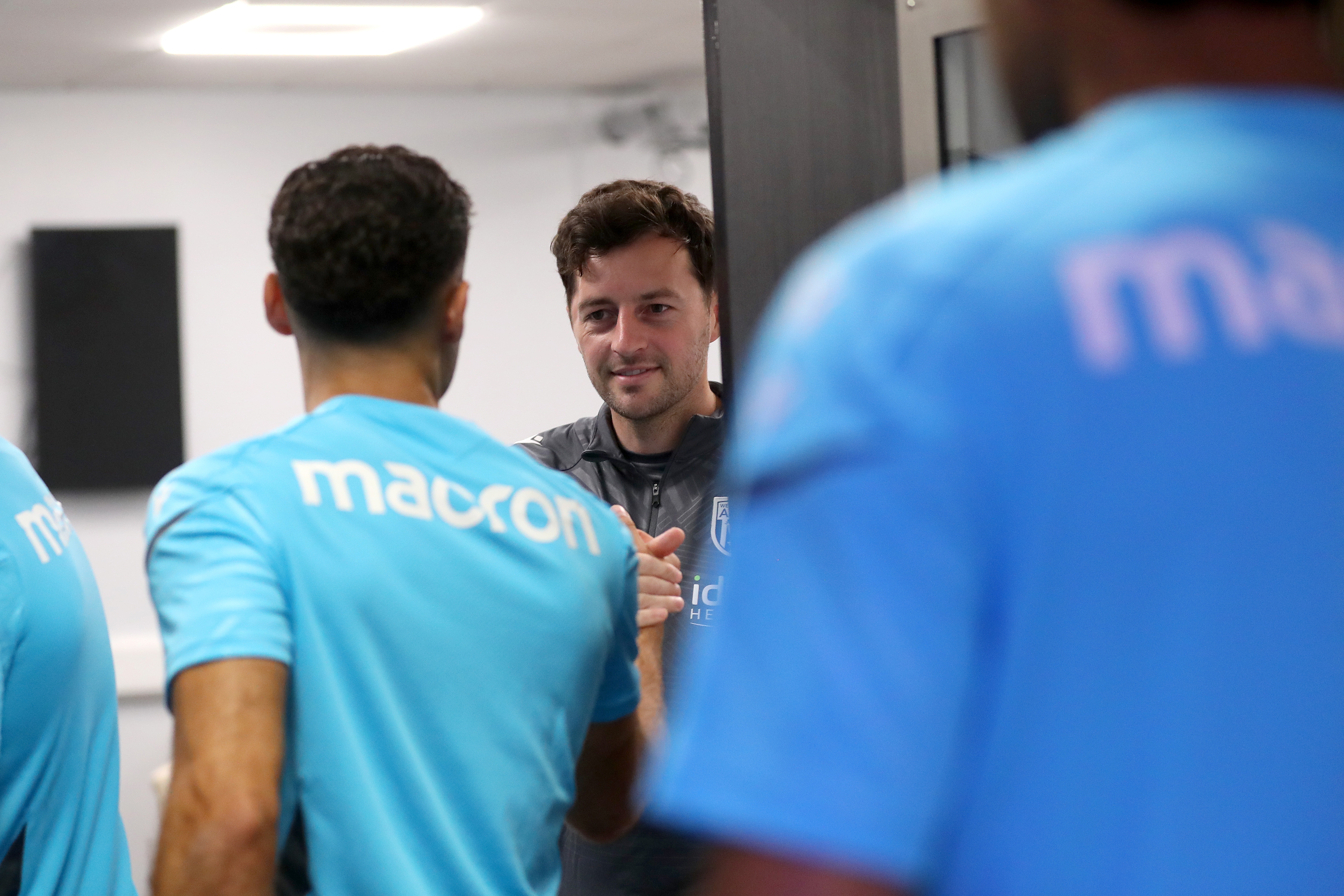 Ryan Mason greeting Albion players before a meeting