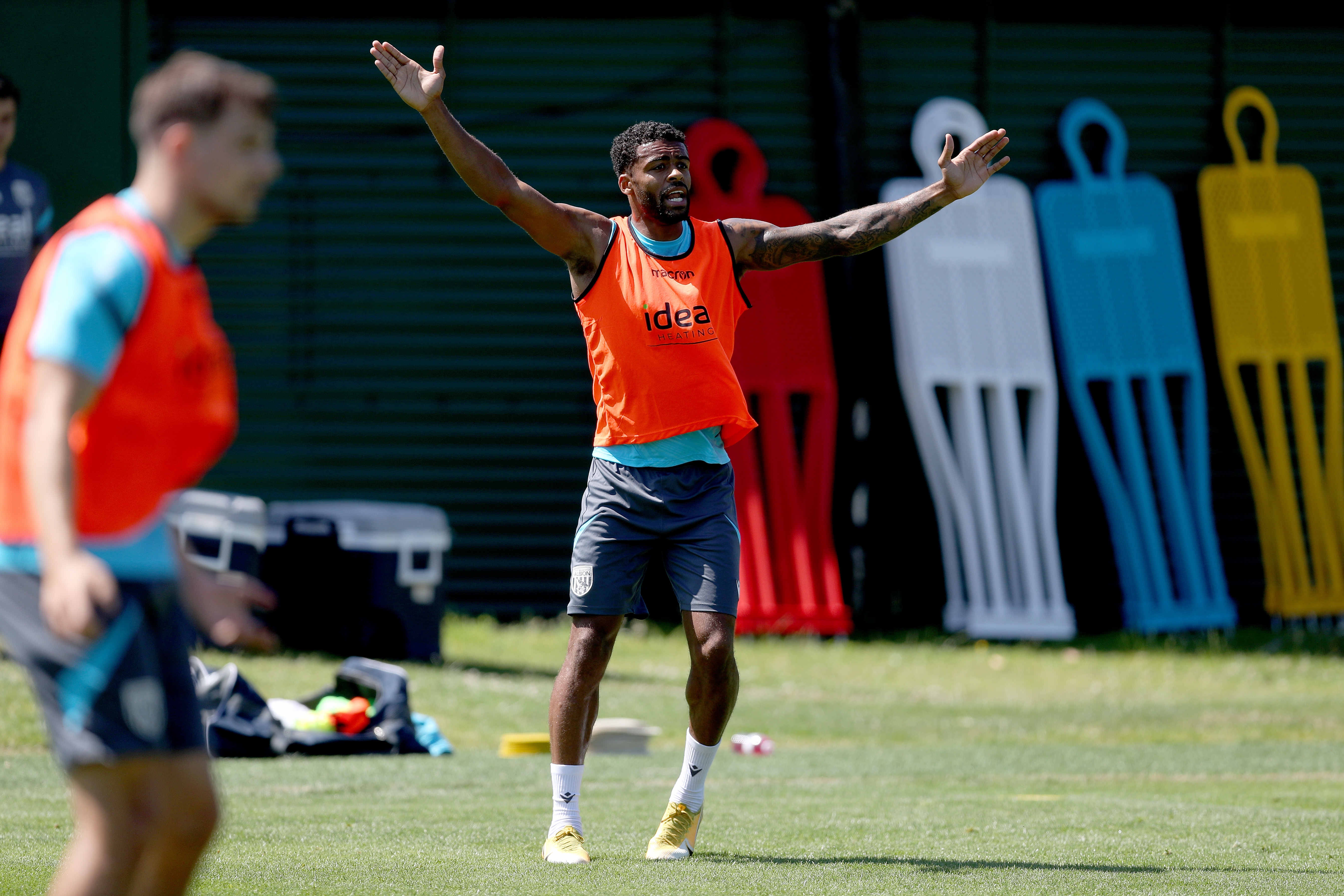 Darnell Furlong with both arms in the air during a training session