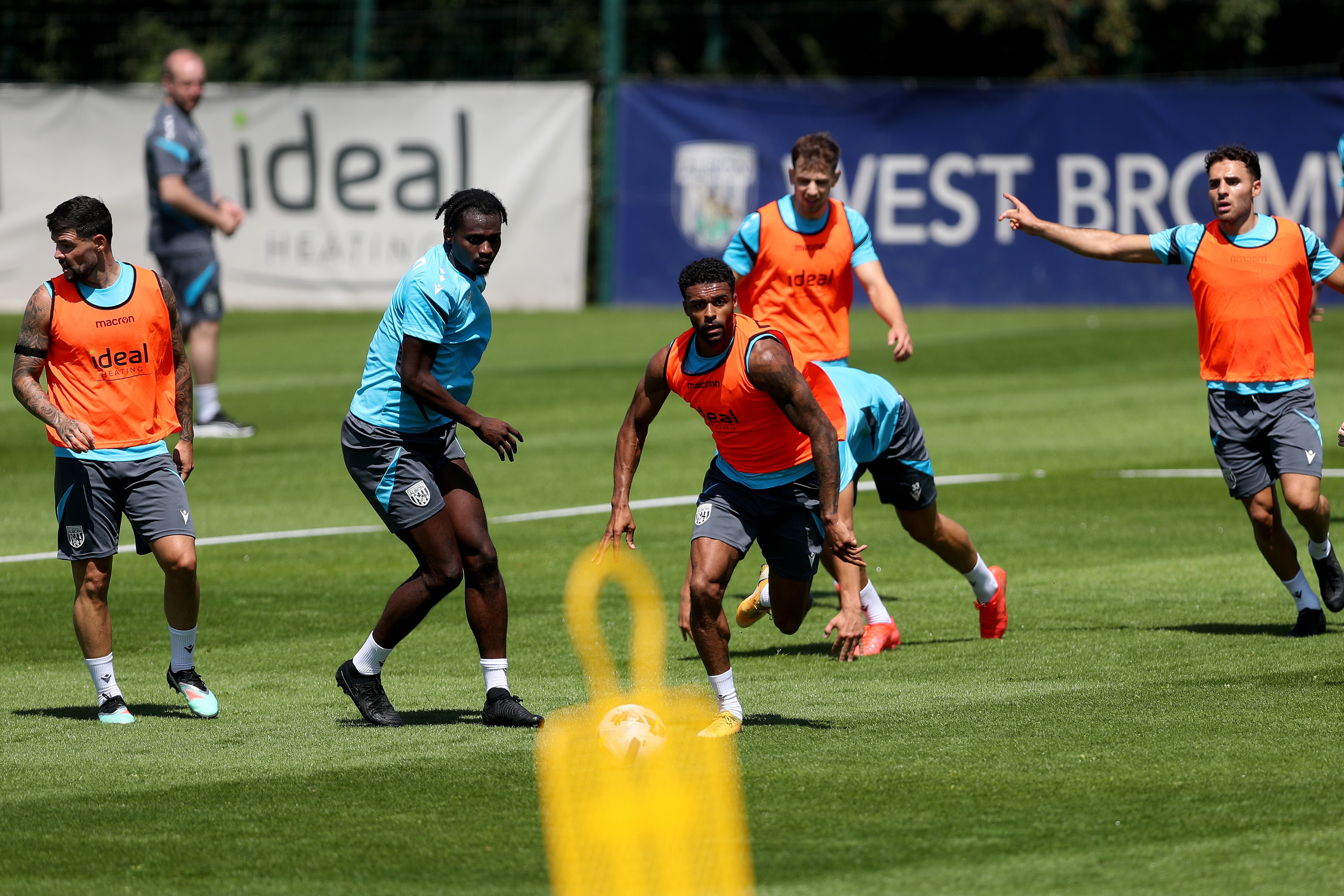 Darnell Furlong running away with the ball during a training session with several players around him