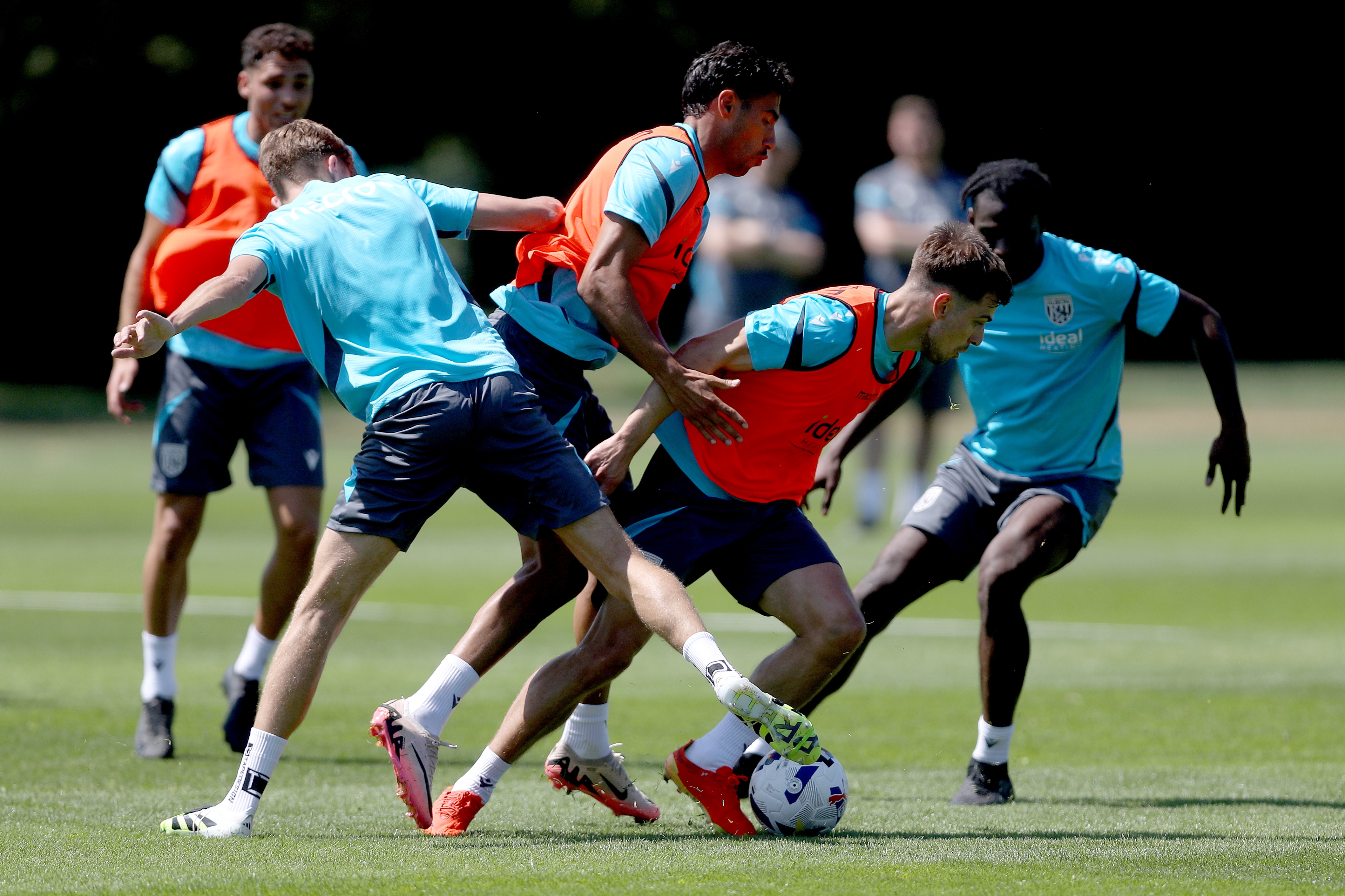 Several players battling for the ball during a training session