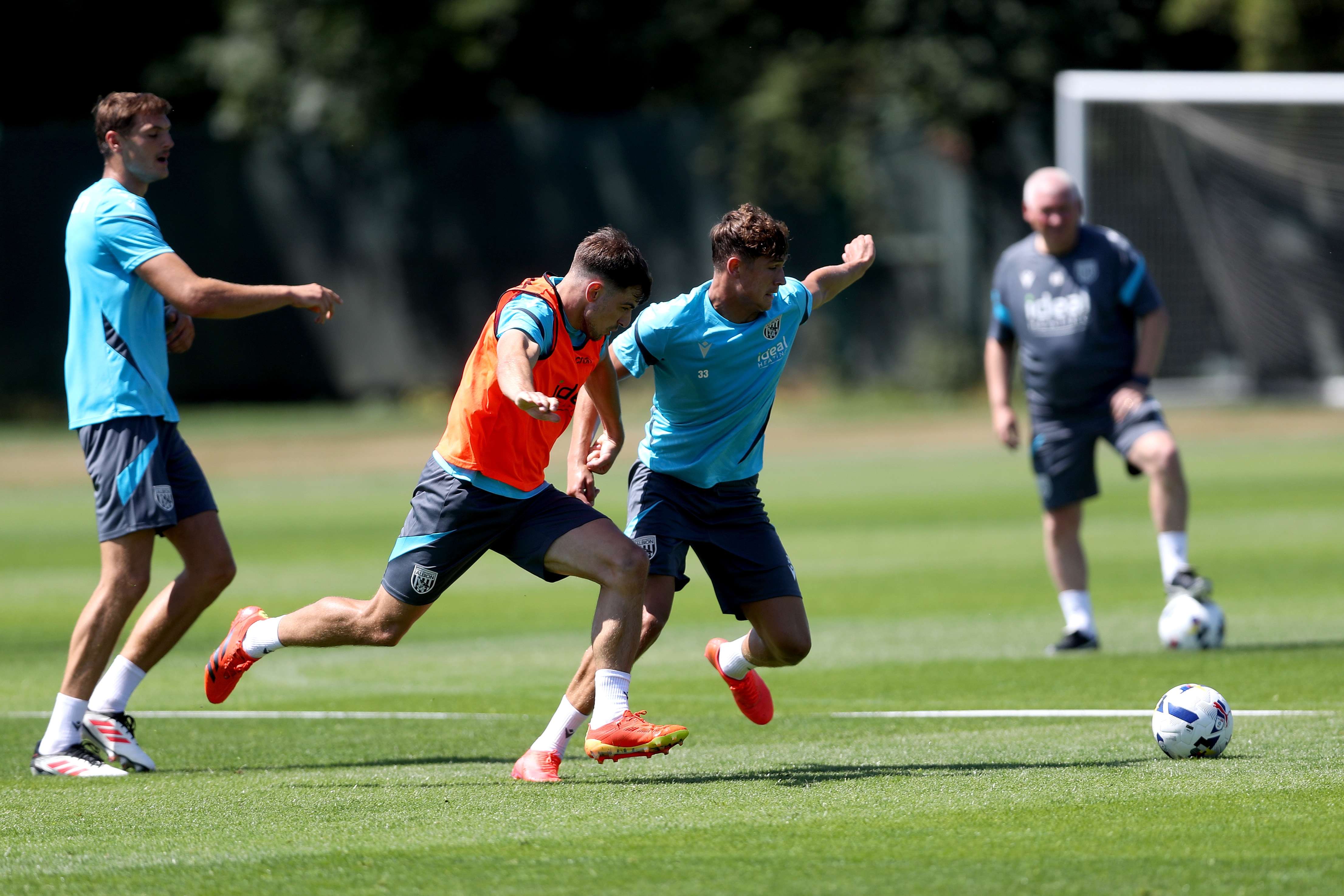 Jayson Molumby and Cole Deeming battling for the ball during a training session