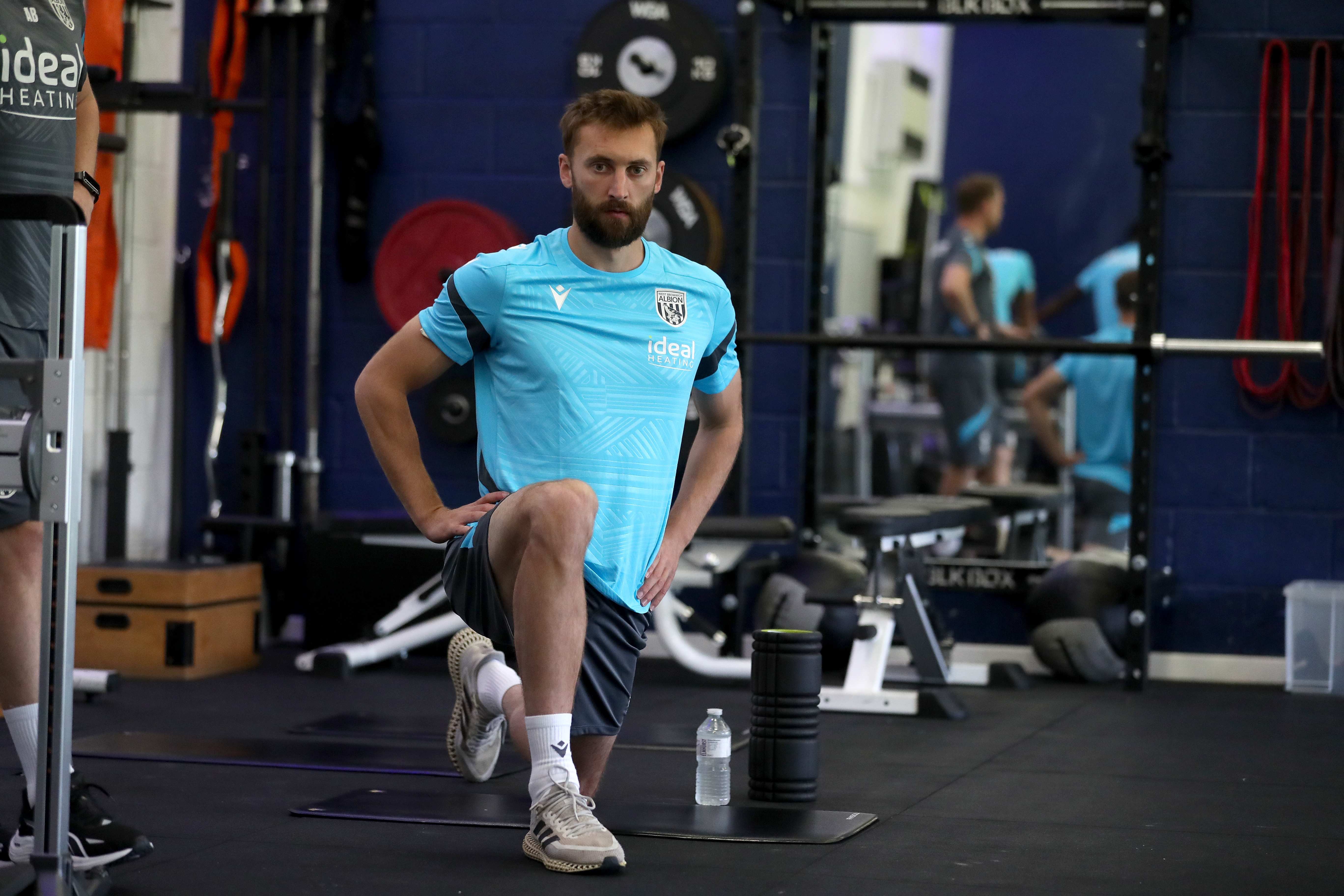 Nat Phillips stretching in the gym