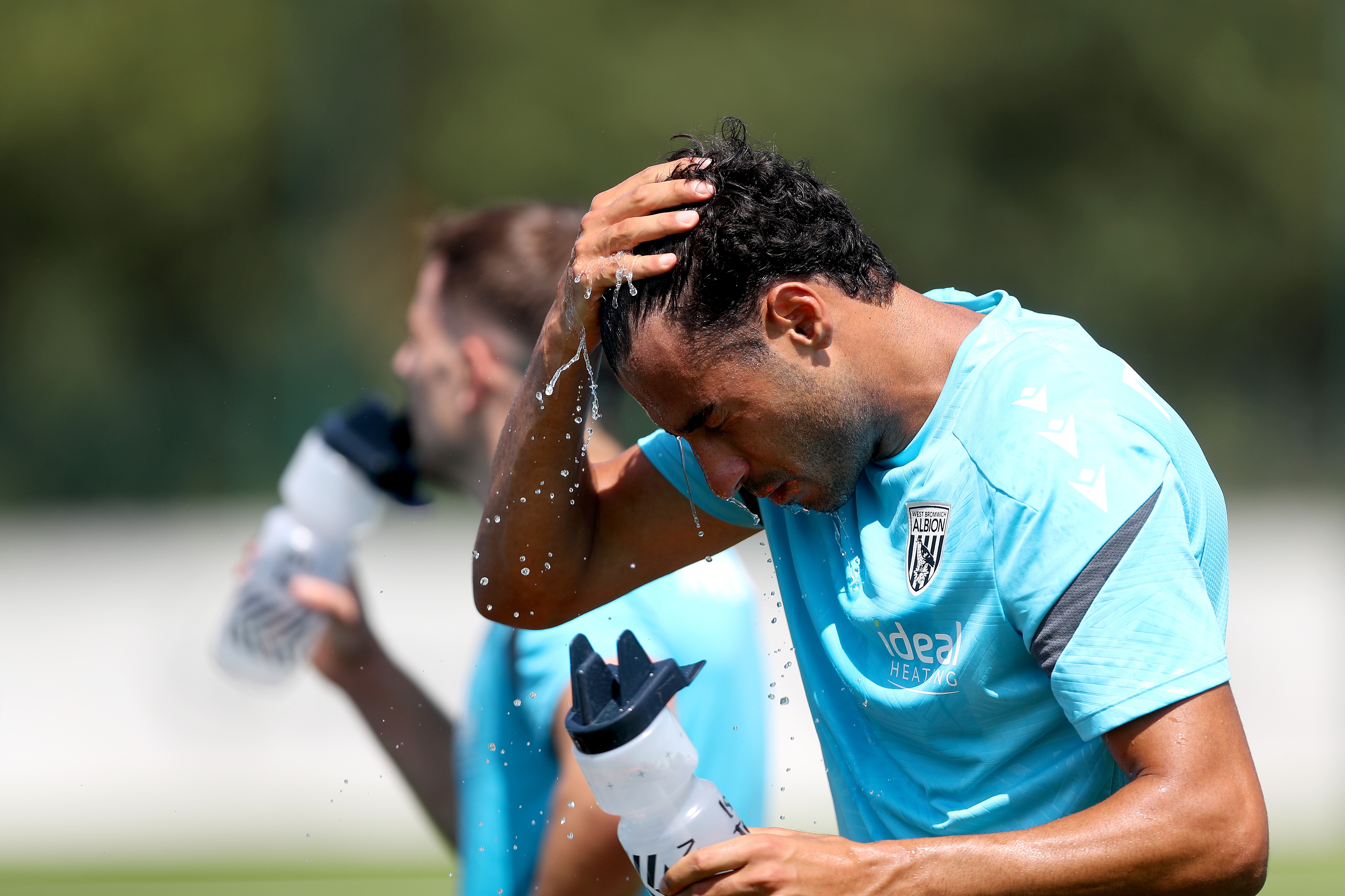 Gianluca Frabotta squirting water into his face during a break in the training session