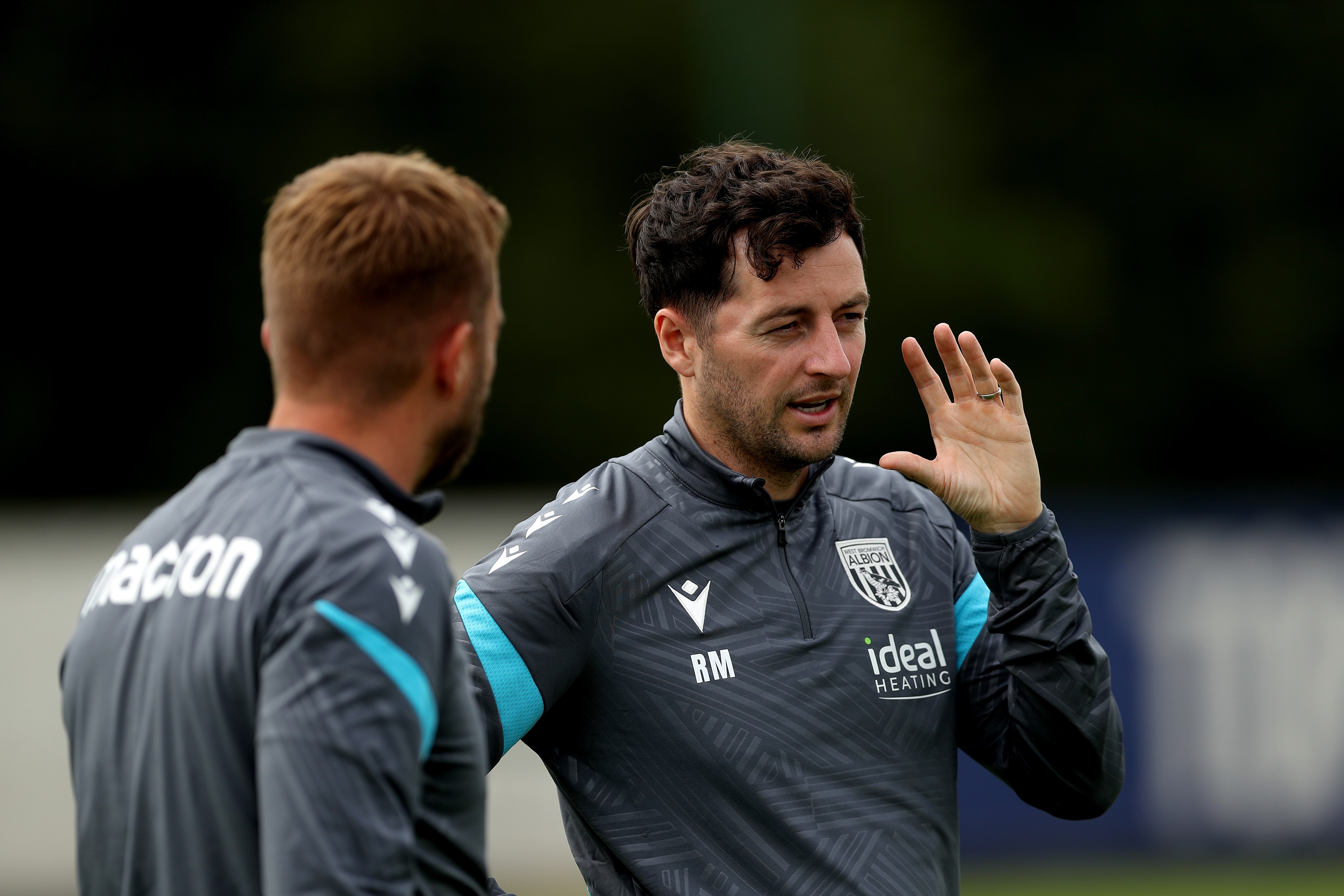 Ryan Mason watching training and talking to James Morrison