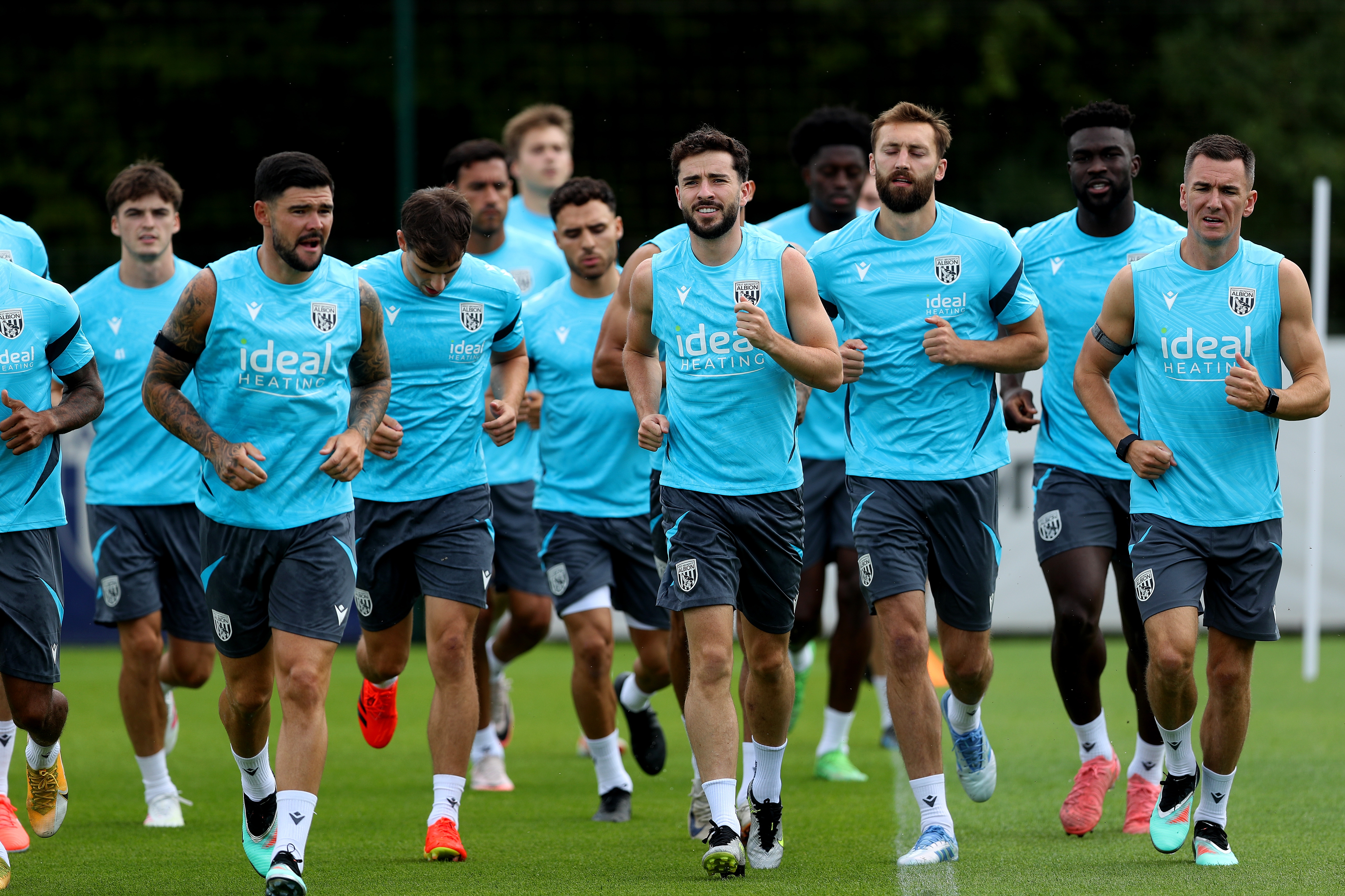Several Albion players jogging during a training session