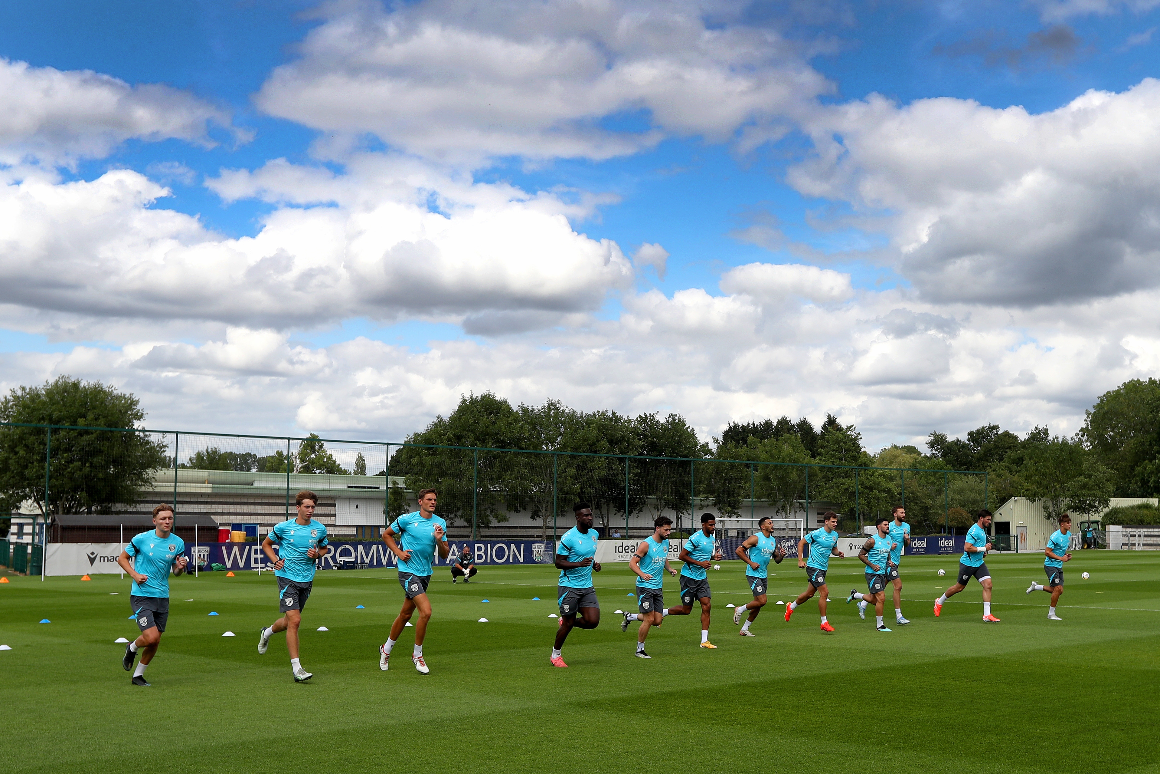 Several Albion players jogging during a training session