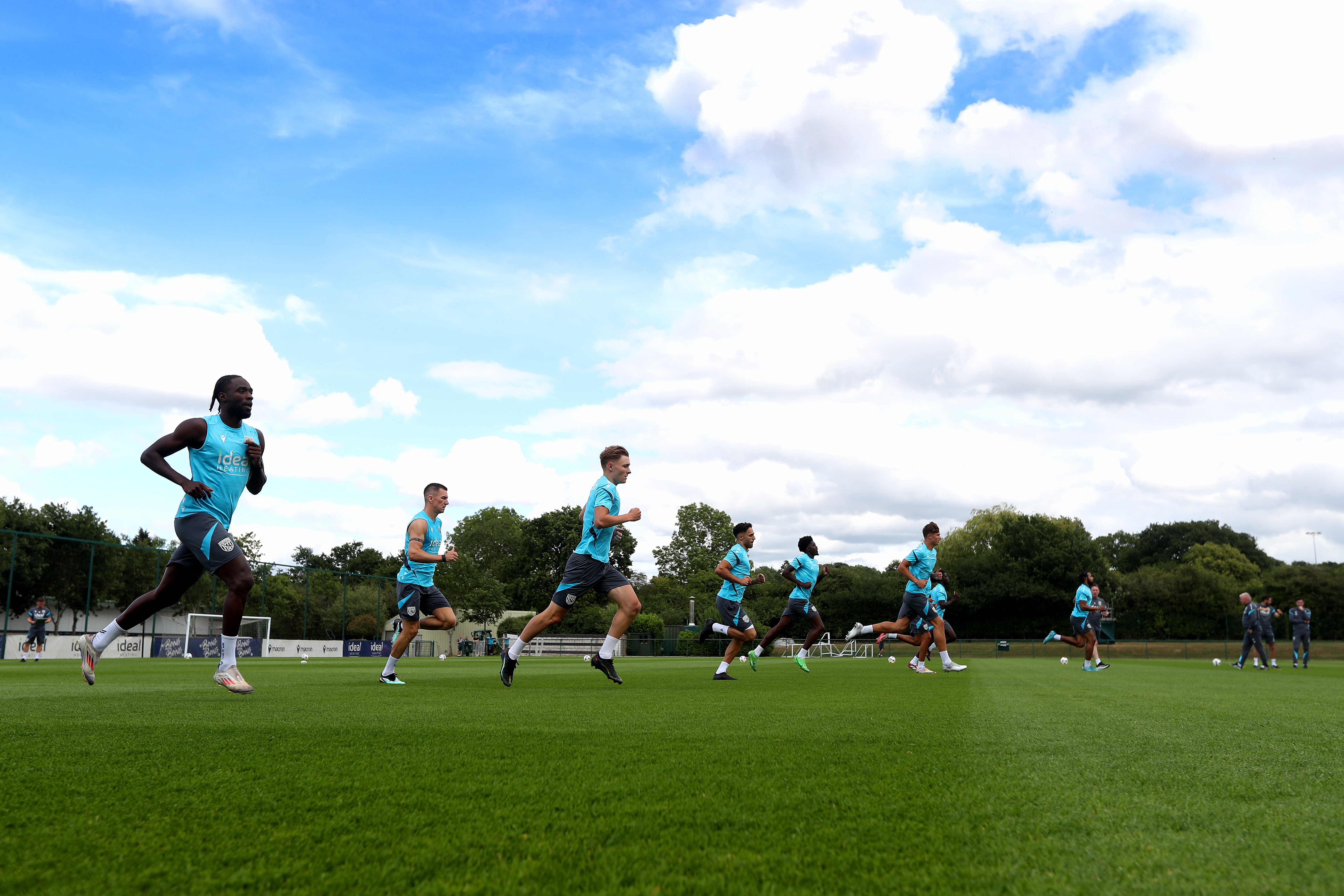 Several Albion players jogging during a training session