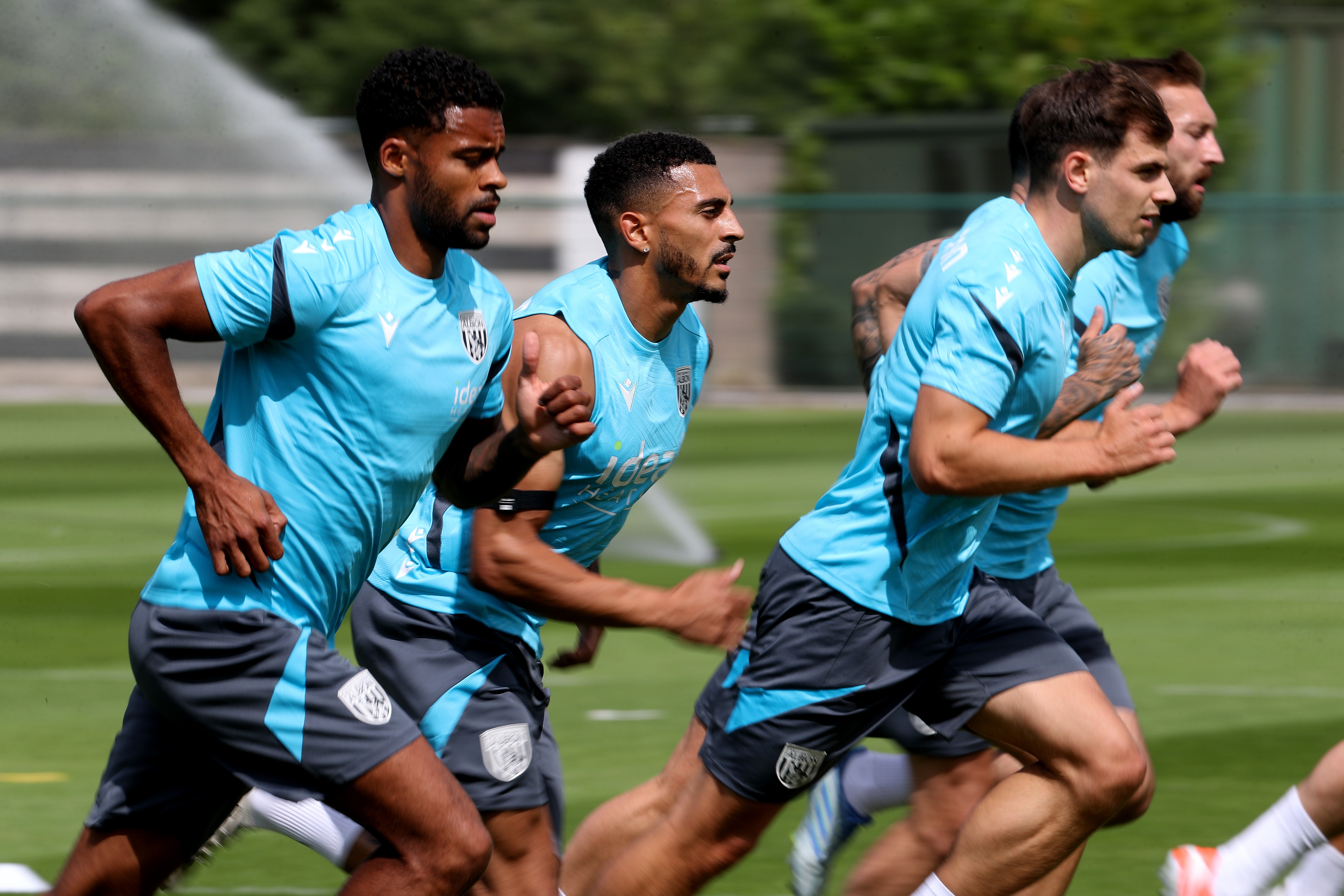 Several Albion players jogging during a training session