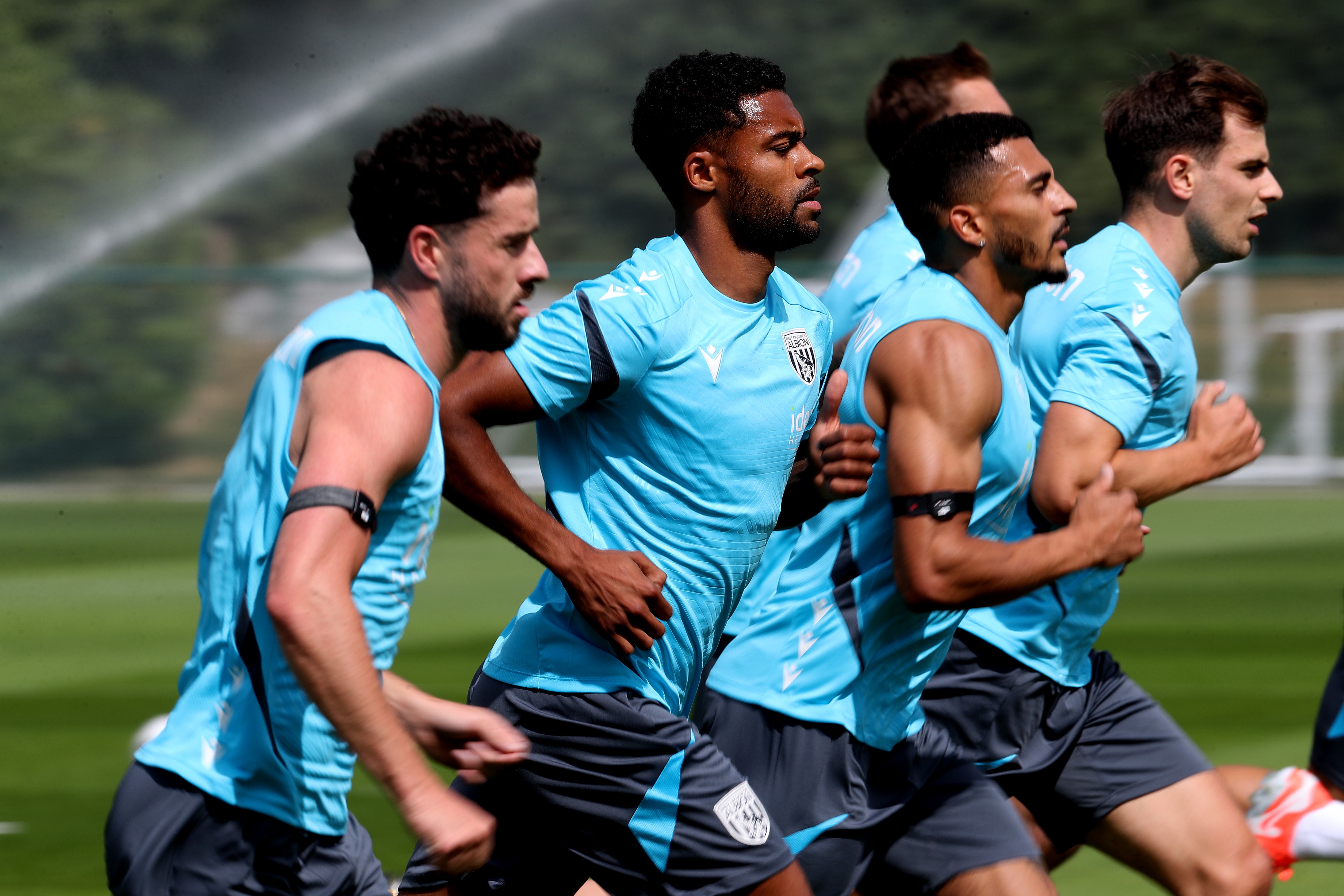 Several Albion players jogging during a training session