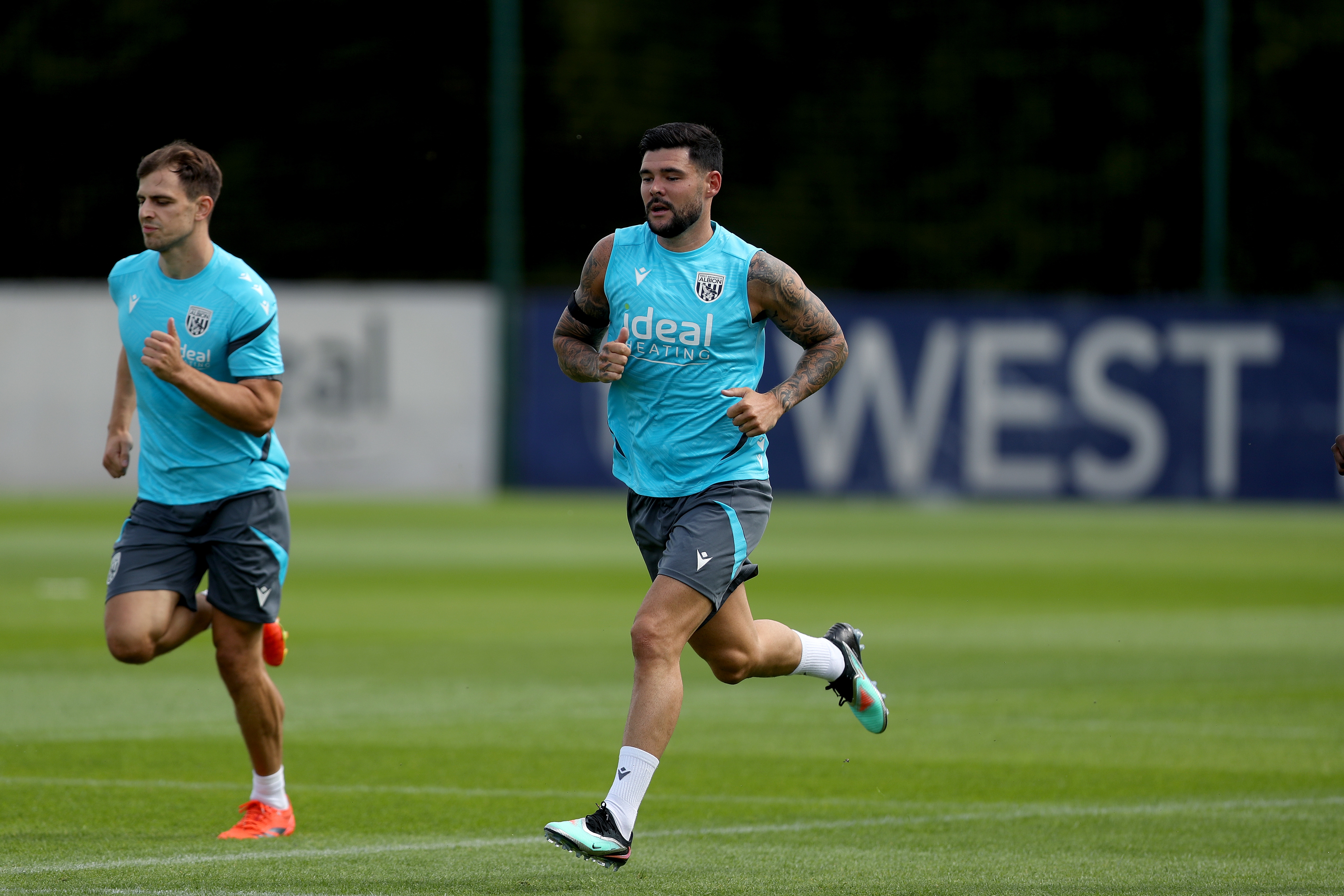 Jayson Molumby and Alex Mowatt running during a training session