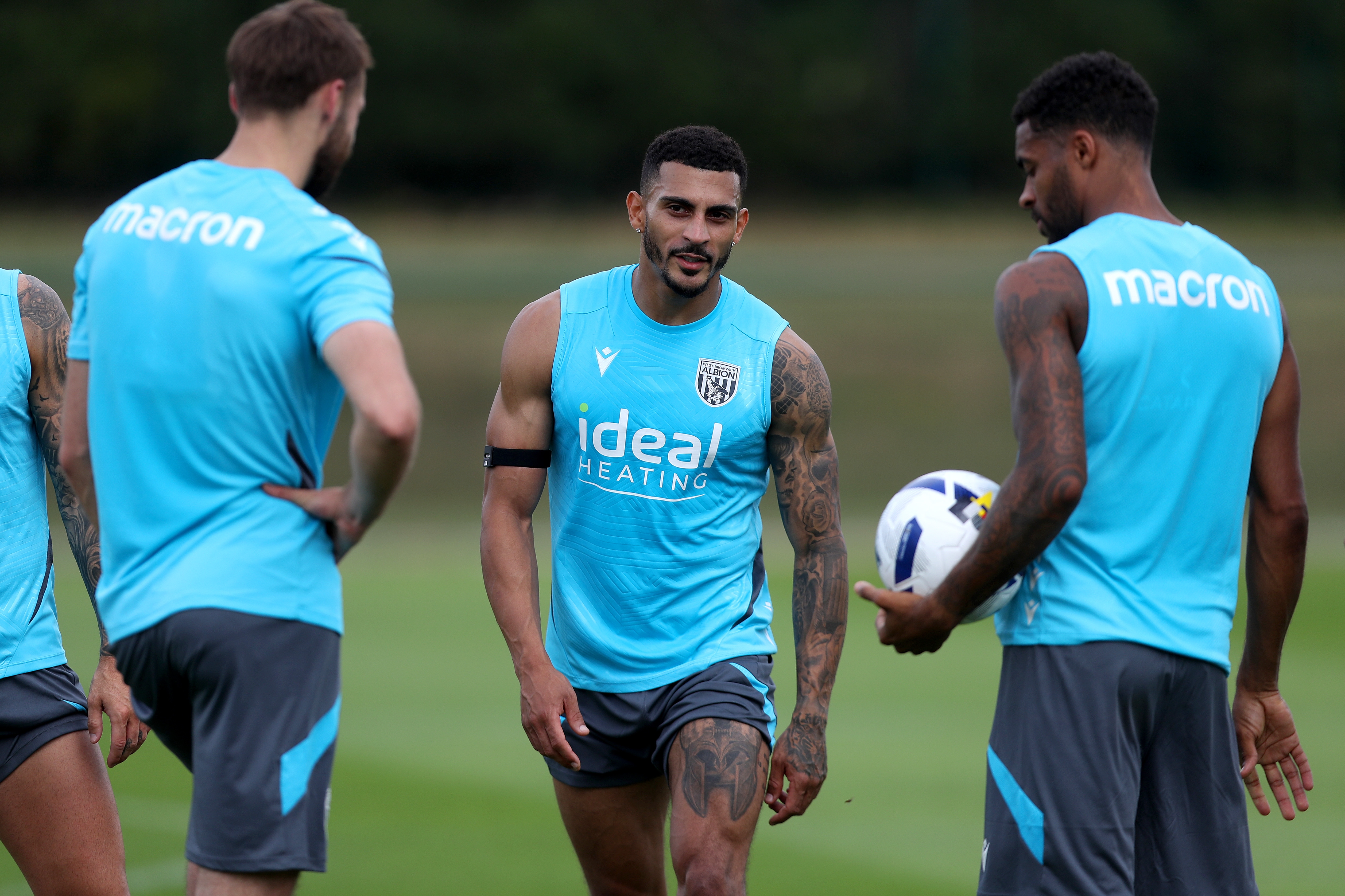 Nat Phillips, Karlan Grant and Darnell Furlong smiling during a training session