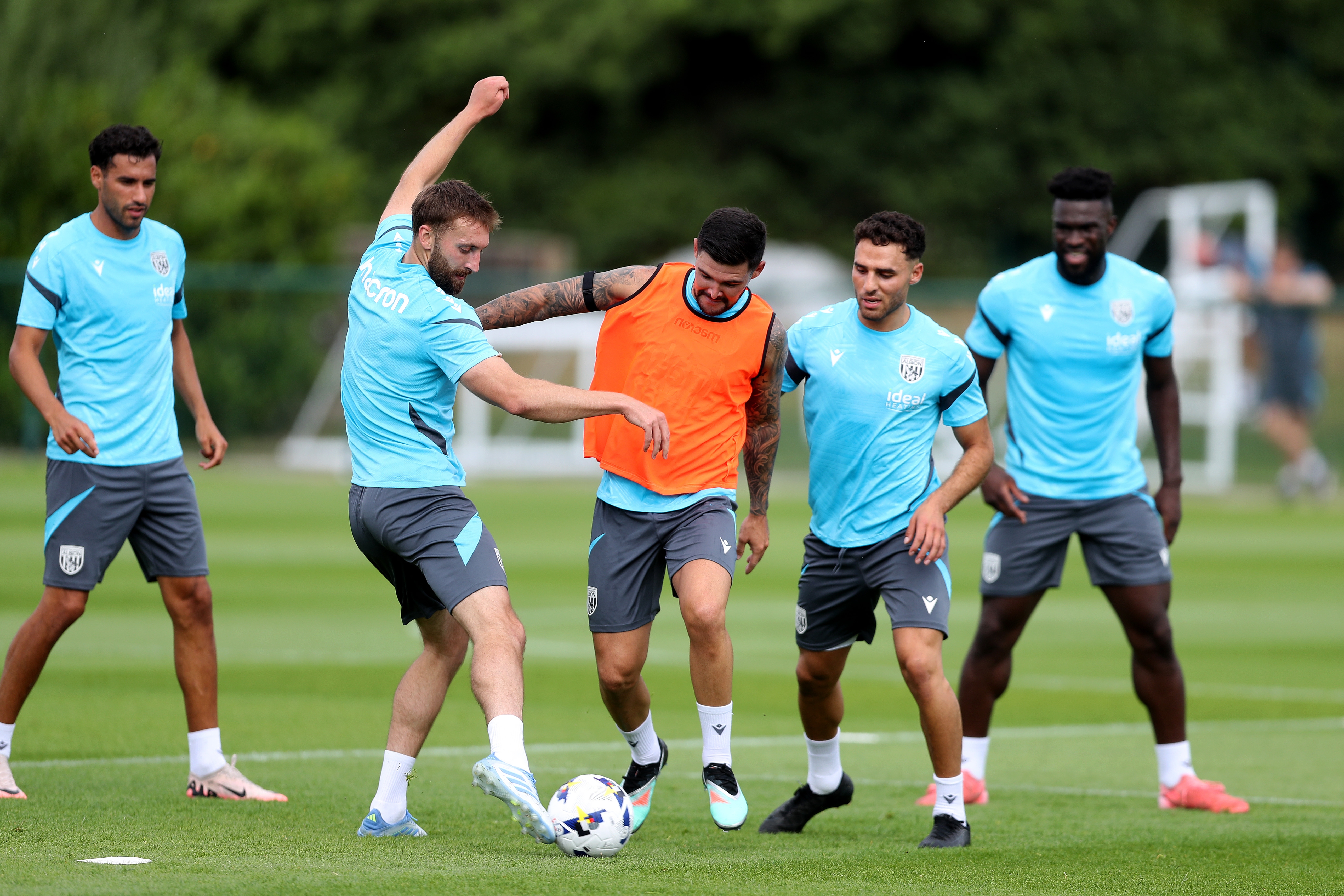 Nat Phillips and Alex Mowatt battle for the ball during a training session