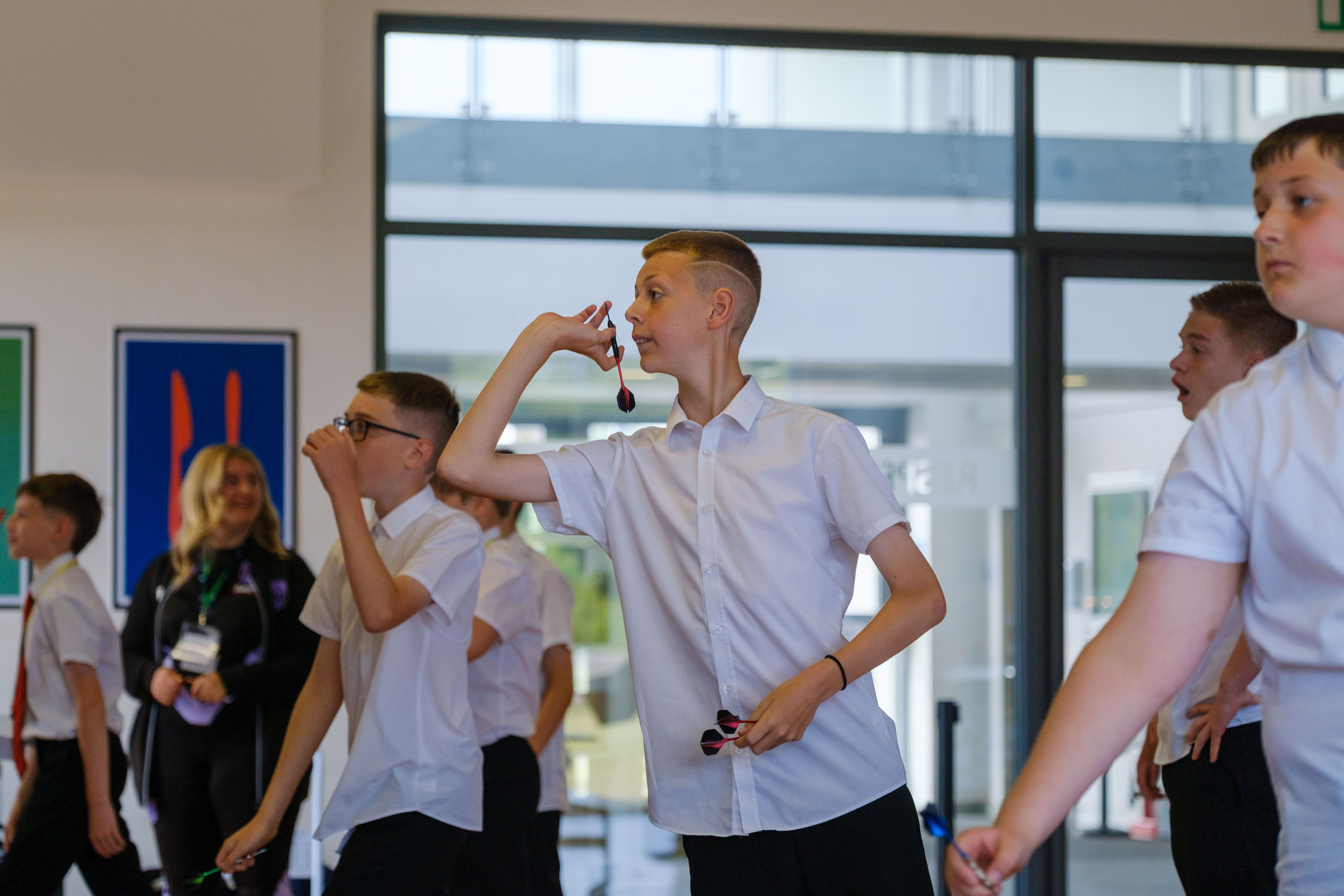 A student takes aim during the darts fundraiser.