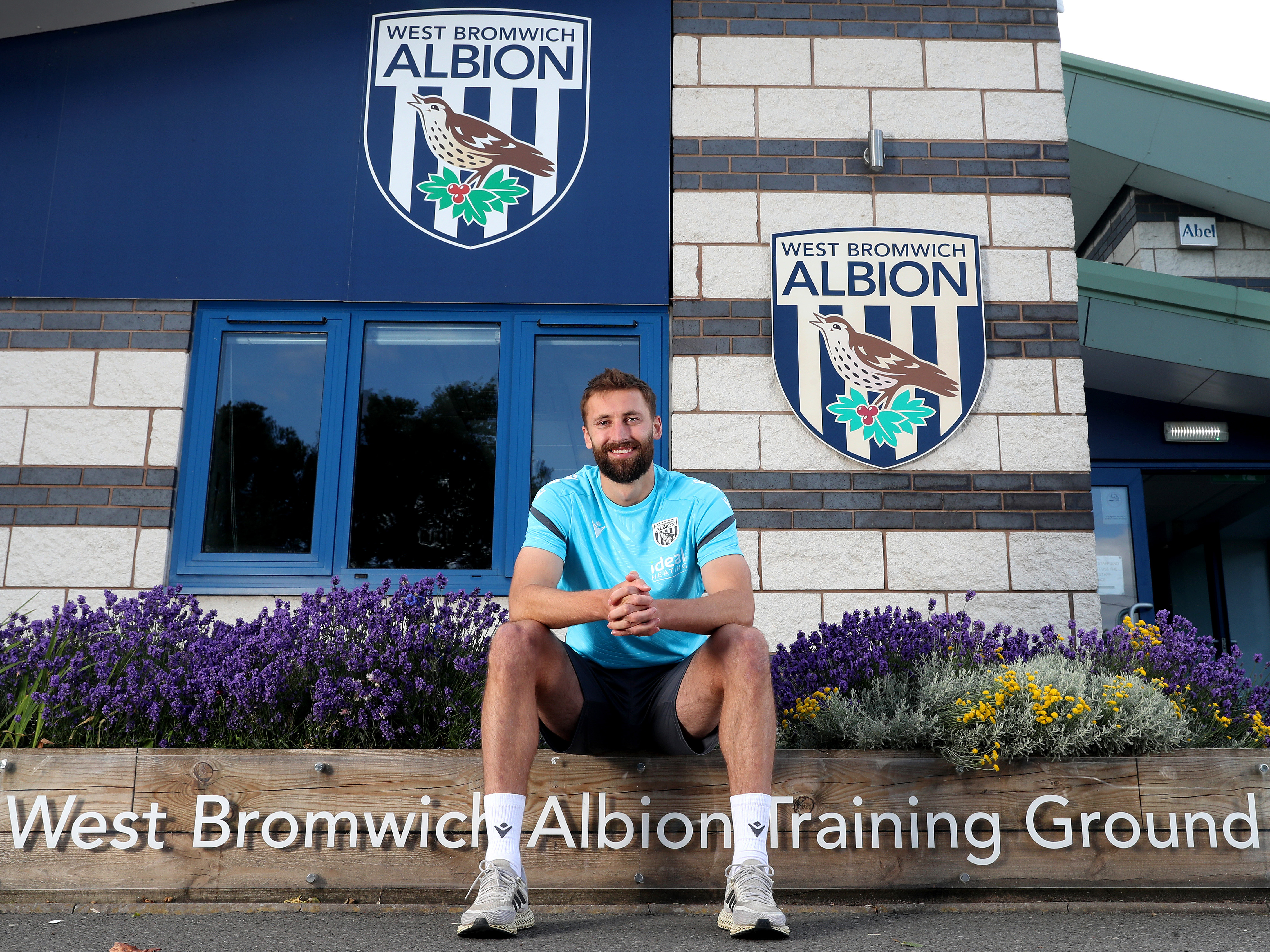 An image of Nat Phillips sat outside the club's training ground