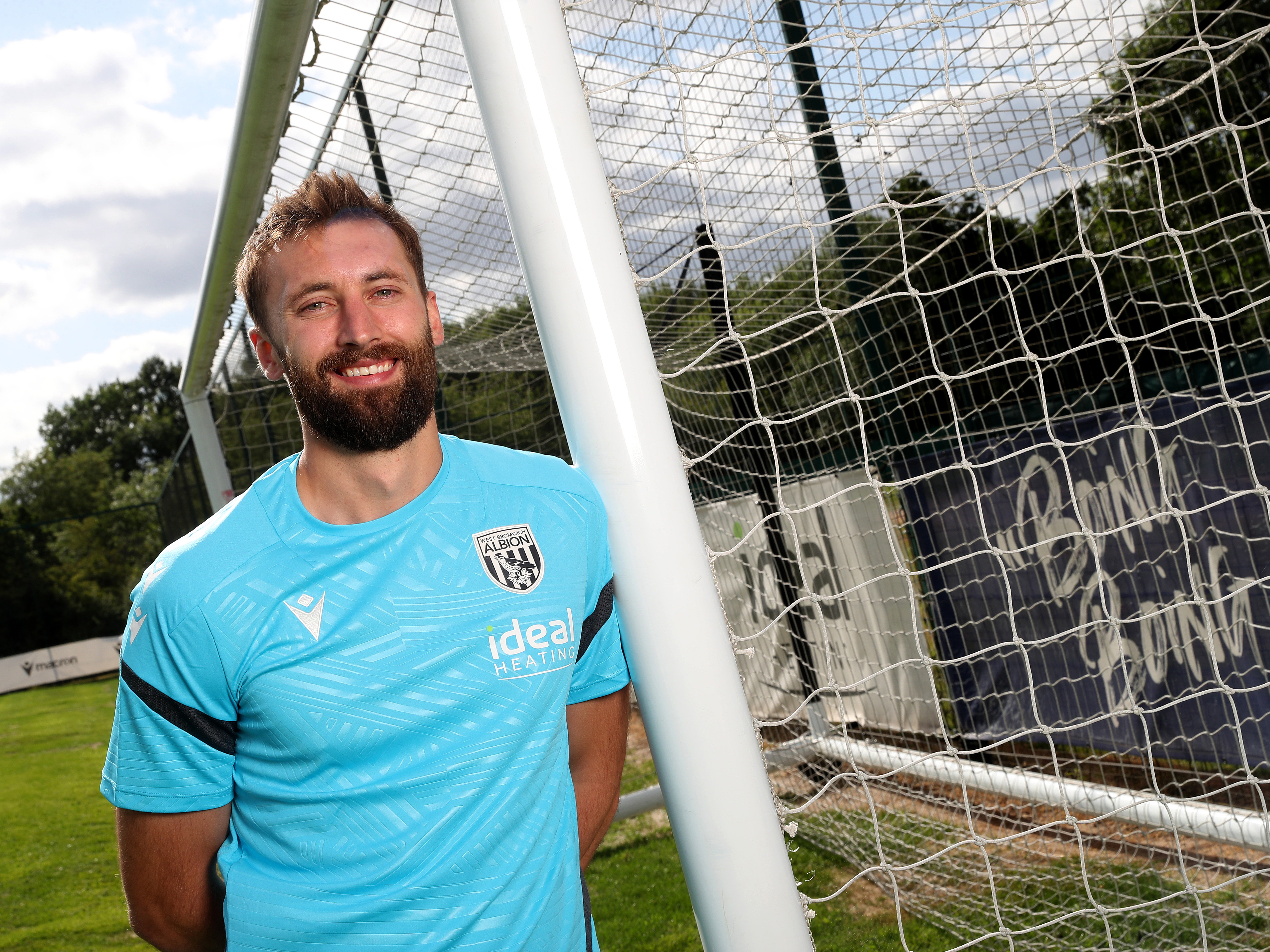 An image of Nat Phillips leaning against a goal-post